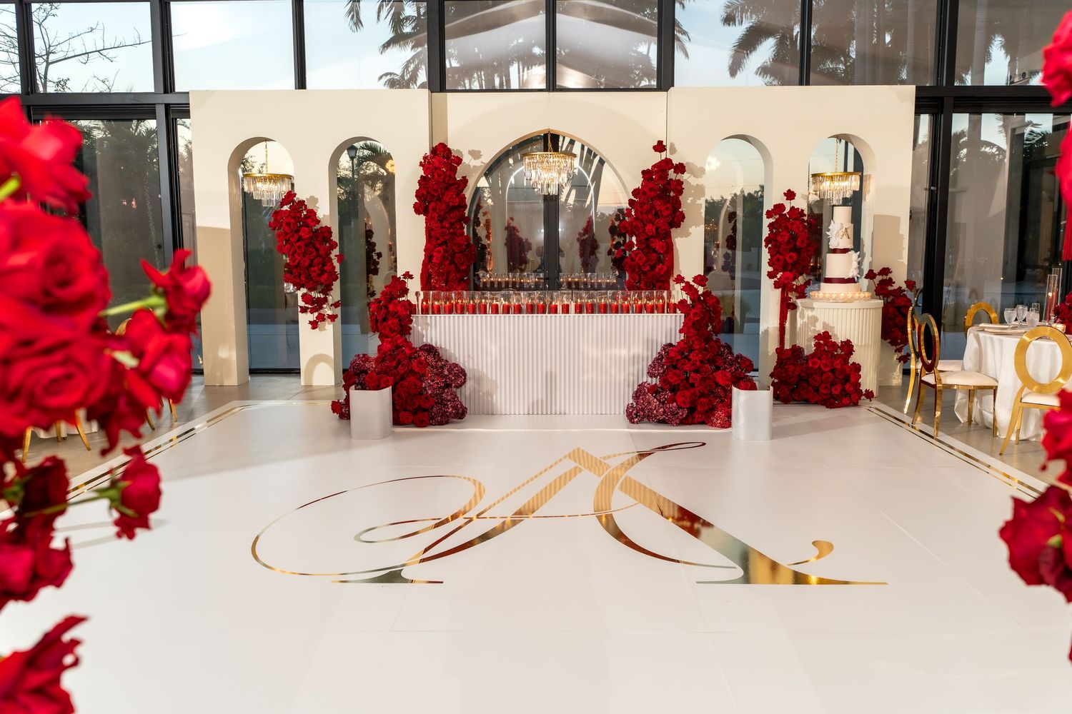 Red balloon art installation decorates a modern shopping mall interior with curved lines and reflective surfaces.