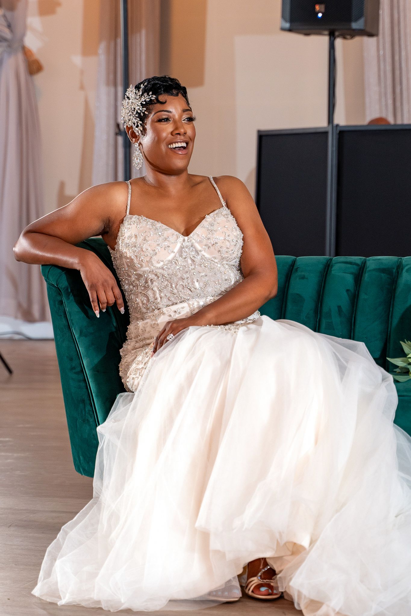 A stunning bridal portrait showcasing an intricately beaded wedding gown and sparkling hair accessories.