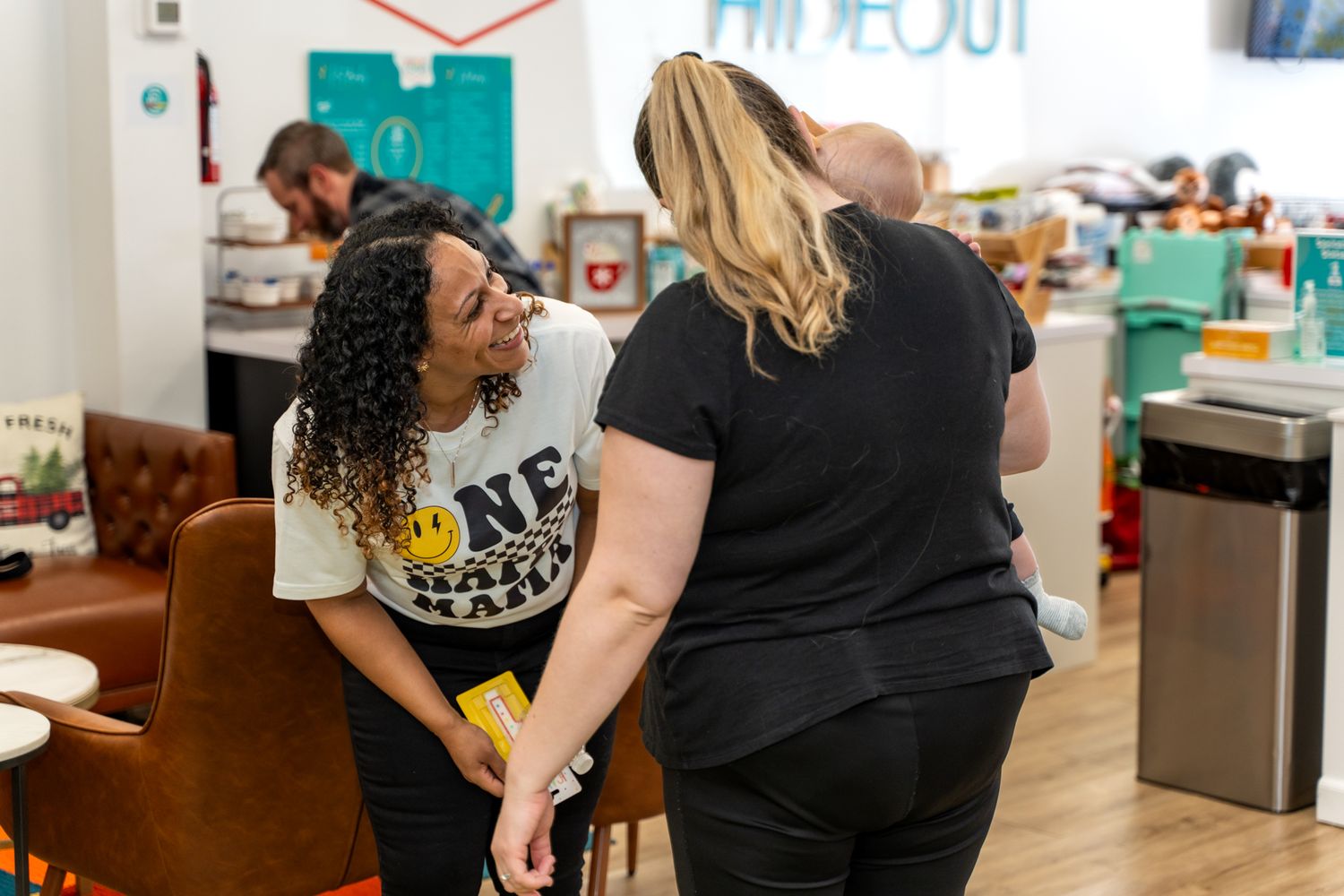 Two people having a conversation in a brightly lit playroom space.
