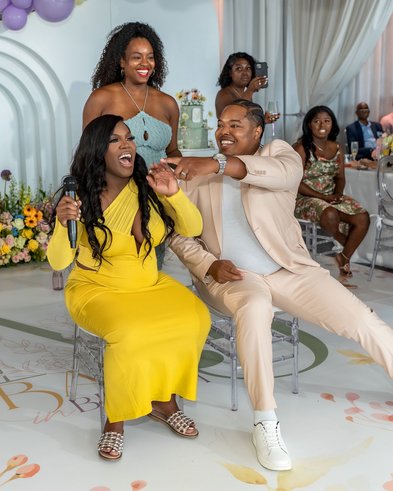Joyful celebration moment captured during a baby shower with elegant decorative touches.