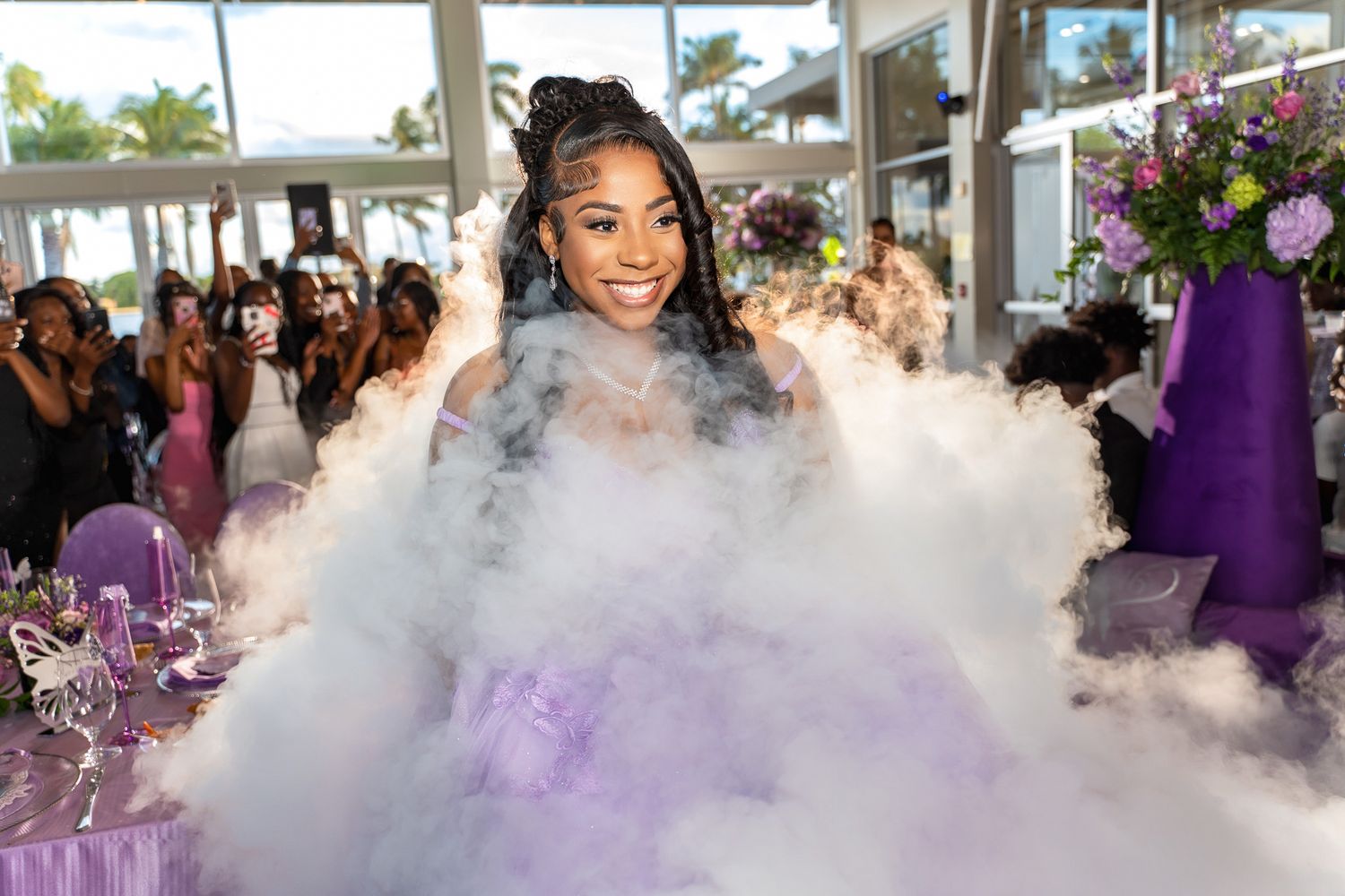 A celebratory scene with dramatic fog effects and purple lighting at a formal event.