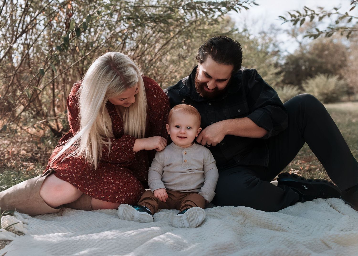 A series of outdoor family photos on a blanket showing intimate moments in a natural setting.