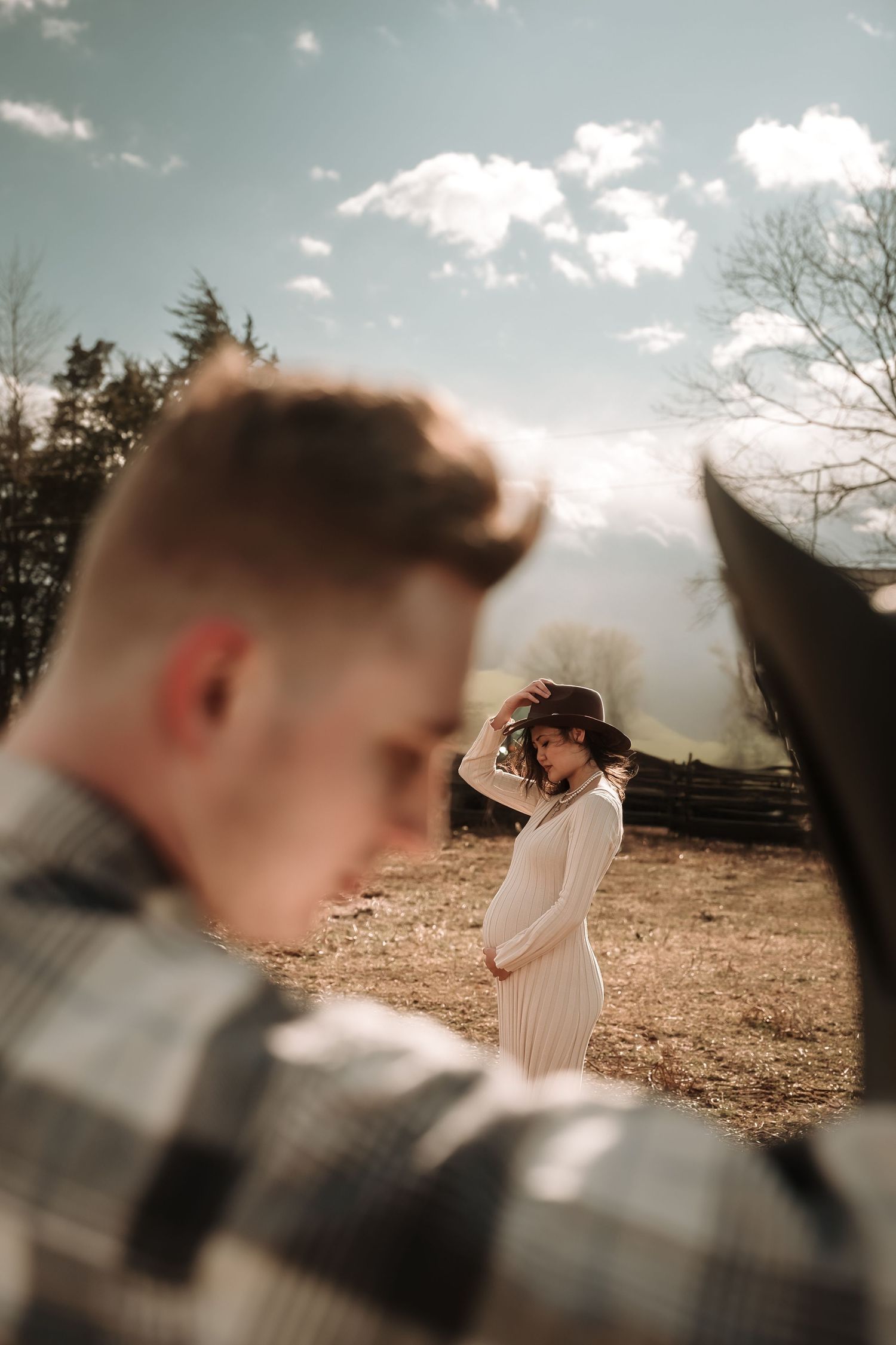 Artistic wedding photography sequence showing multiple angles of a couple in a sunlit outdoor field.