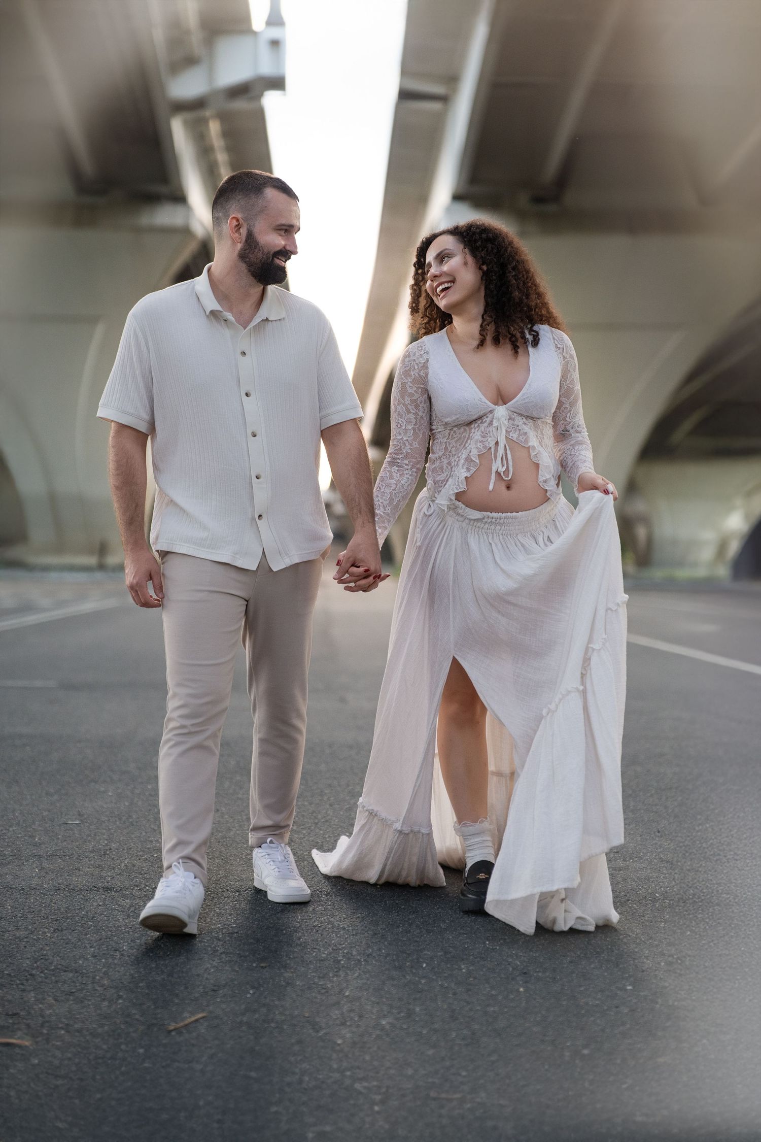 People walking in coordinated white outfits captured from a low angle in an urban setting.