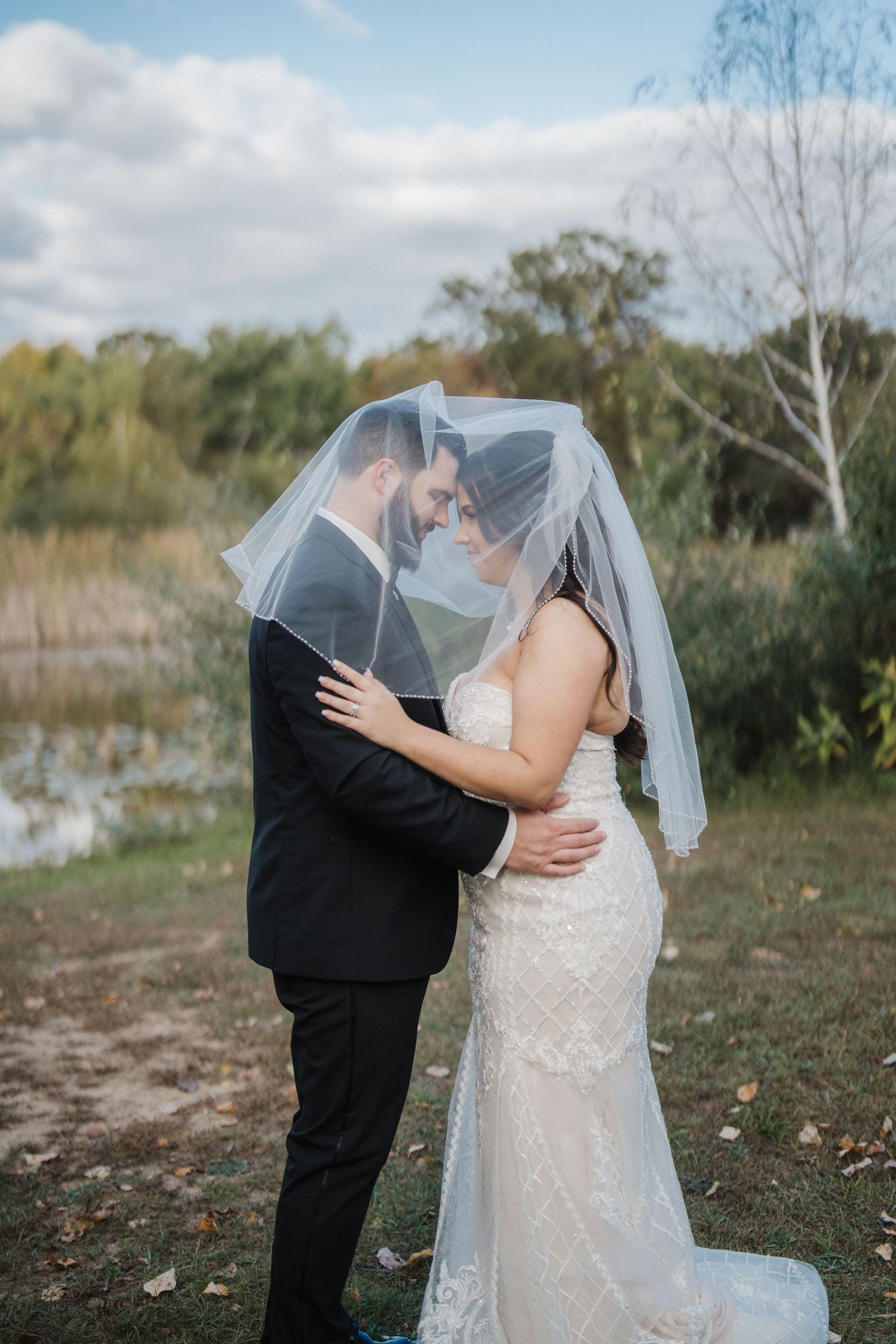 Intimate wedding portraits showing romantic moments between newlyweds under cloudy skies.