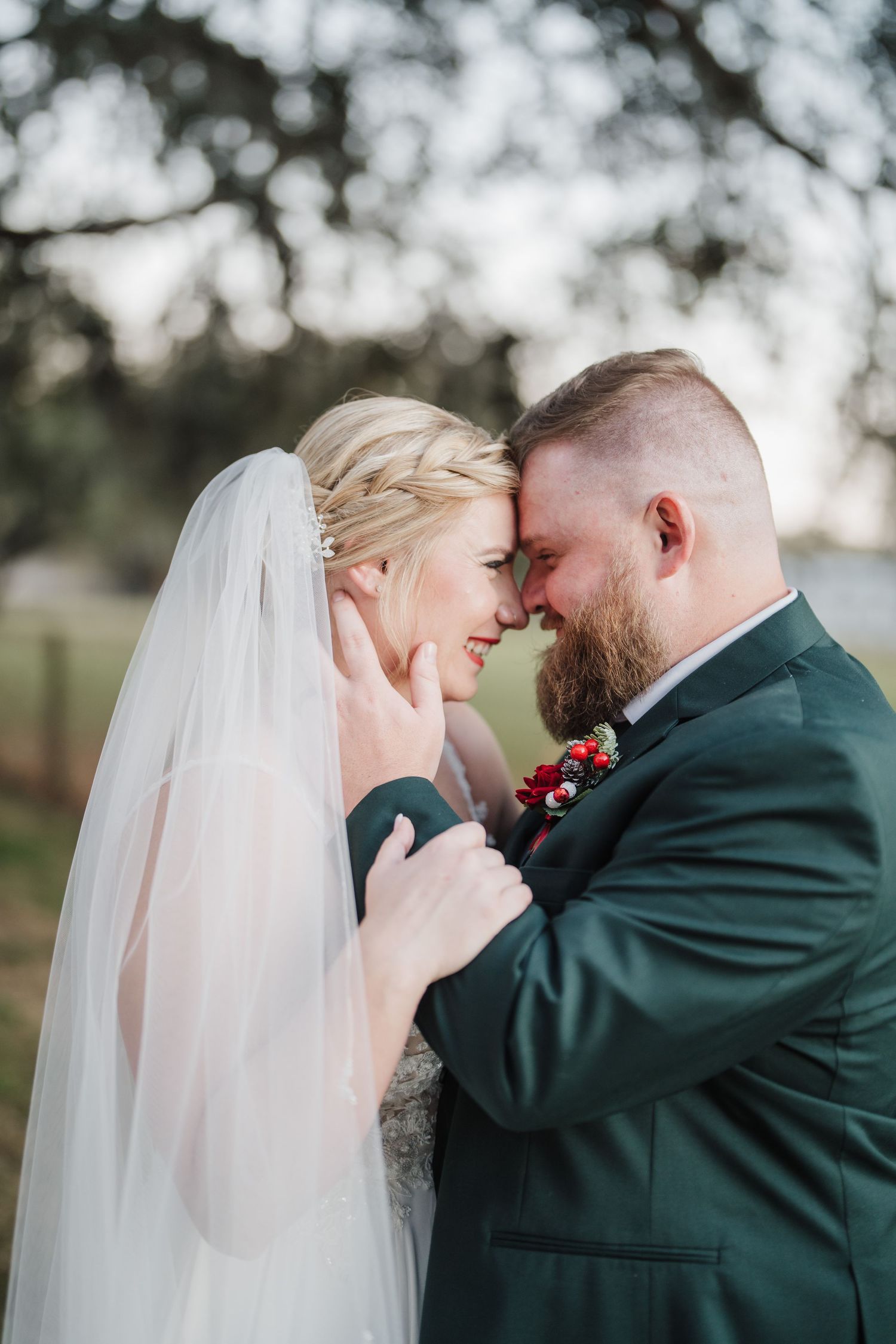 An emotional wedding moment captured as newlyweds share a close embrace outdoors.