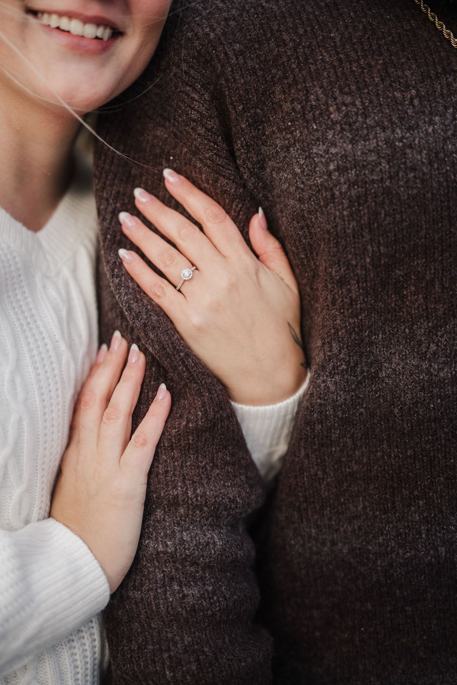 A series of four similar photos showing hands with an engagement ring against a dark brown sweater background.