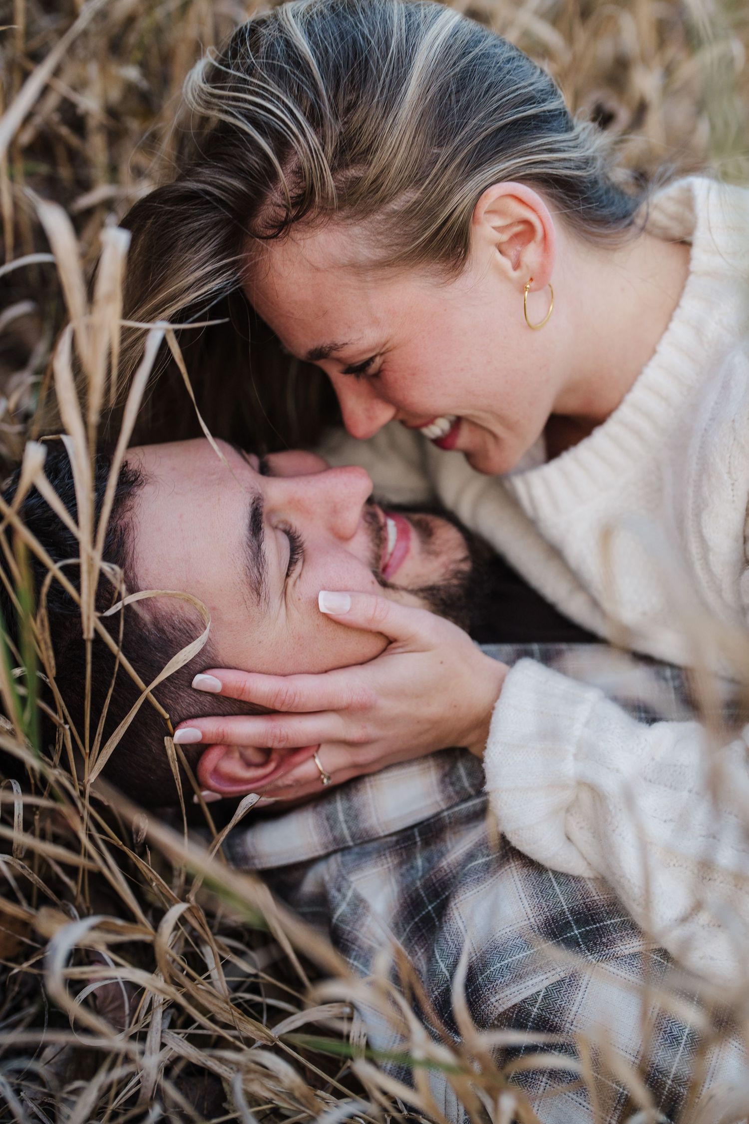 Series of intimate black and white photos showing tender moments between a couple in tall grass.