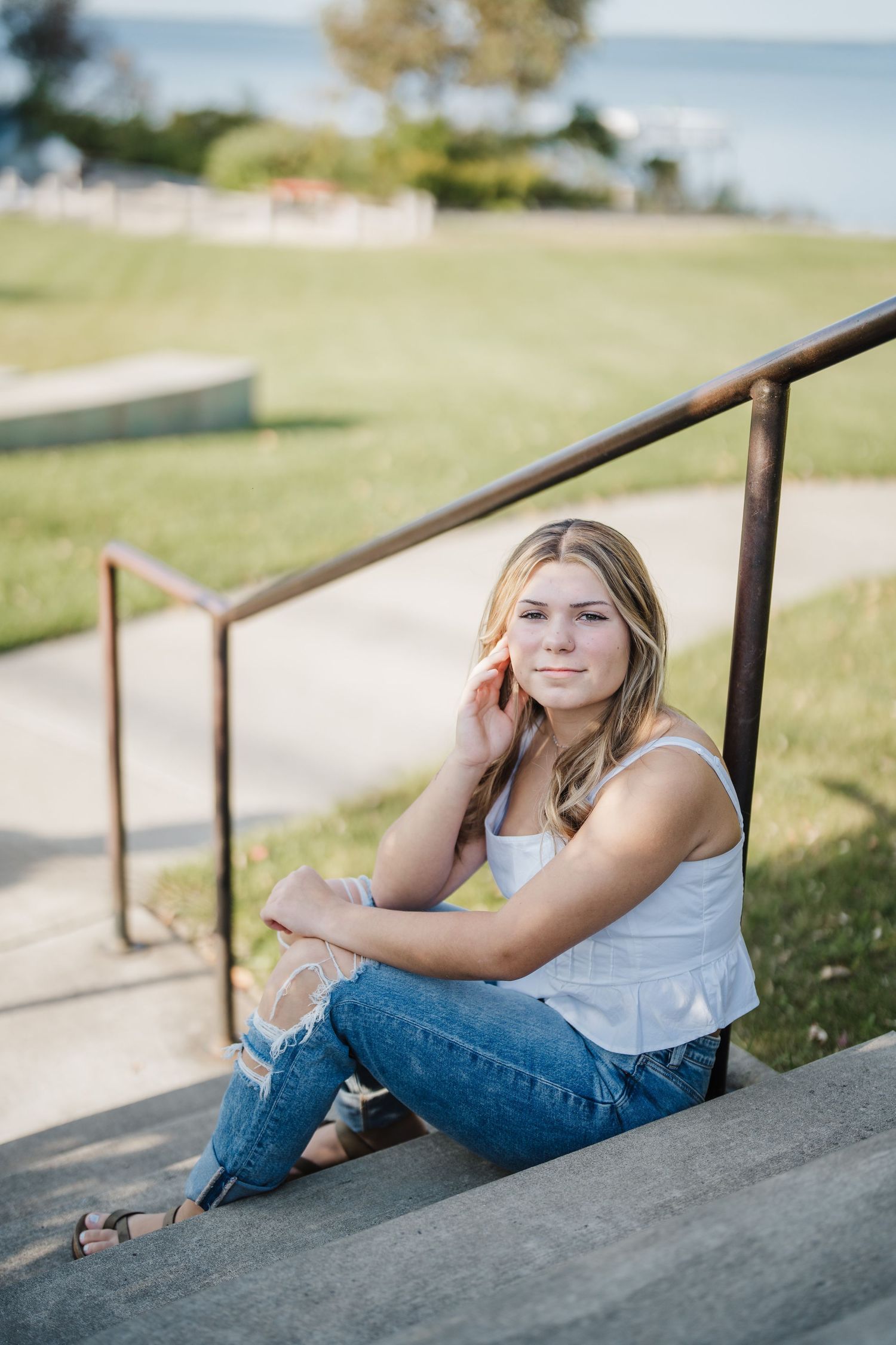 A series of artistic outdoor portrait shots showing casual poses against a railing in natural lighting.