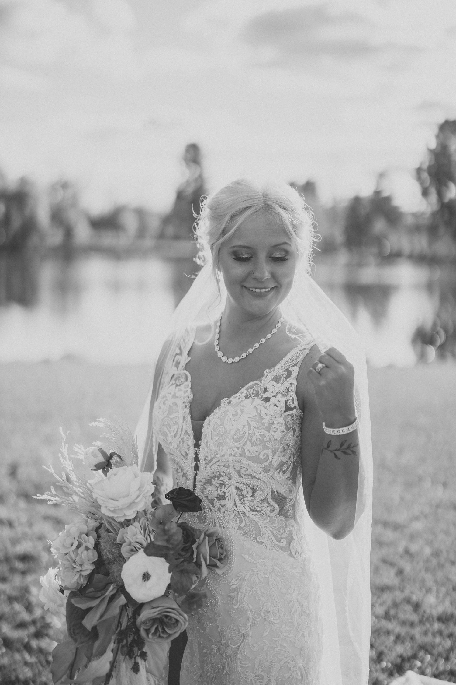Black and white photos show a bride in a lace wedding dress holding a floral bouquet in an outdoor setting.