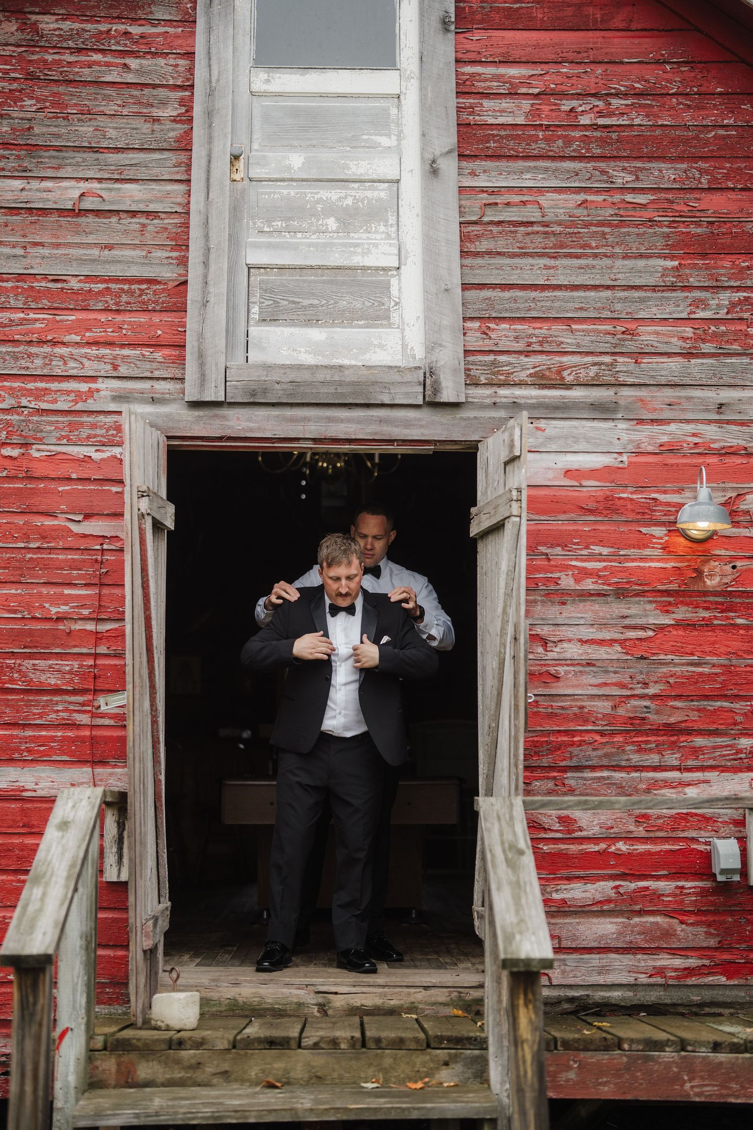 A sequence of images showing someone emerging from a rustic doorway of an old red barn with peeling paint.