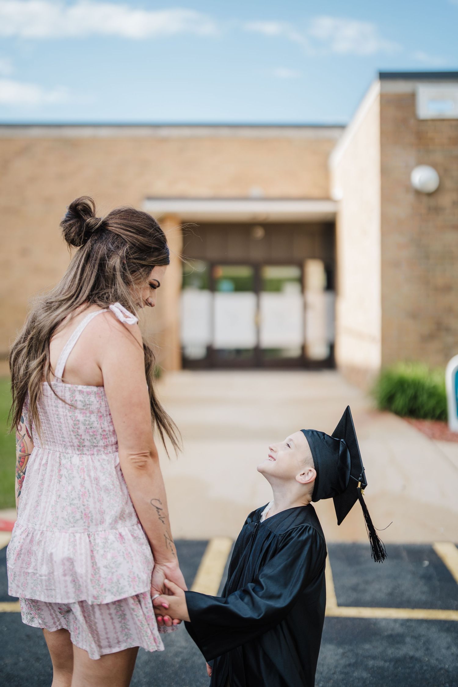 A series of candid moments showing a person in a pink dress interacting with someone in graduation attire.