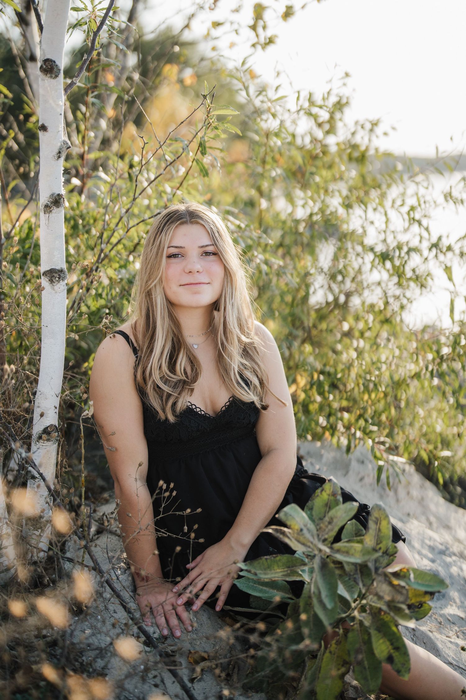 Natural outdoor portraits among birch trees and foliage in dappled sunlight.