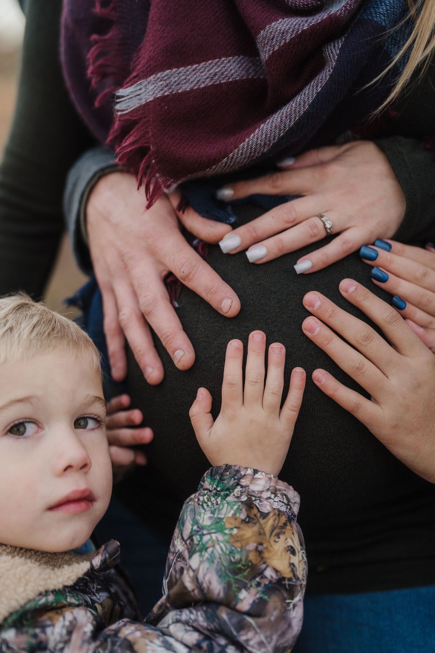 A series of five connected photos showing gentle hands touching and caressing in an intimate family moment.
