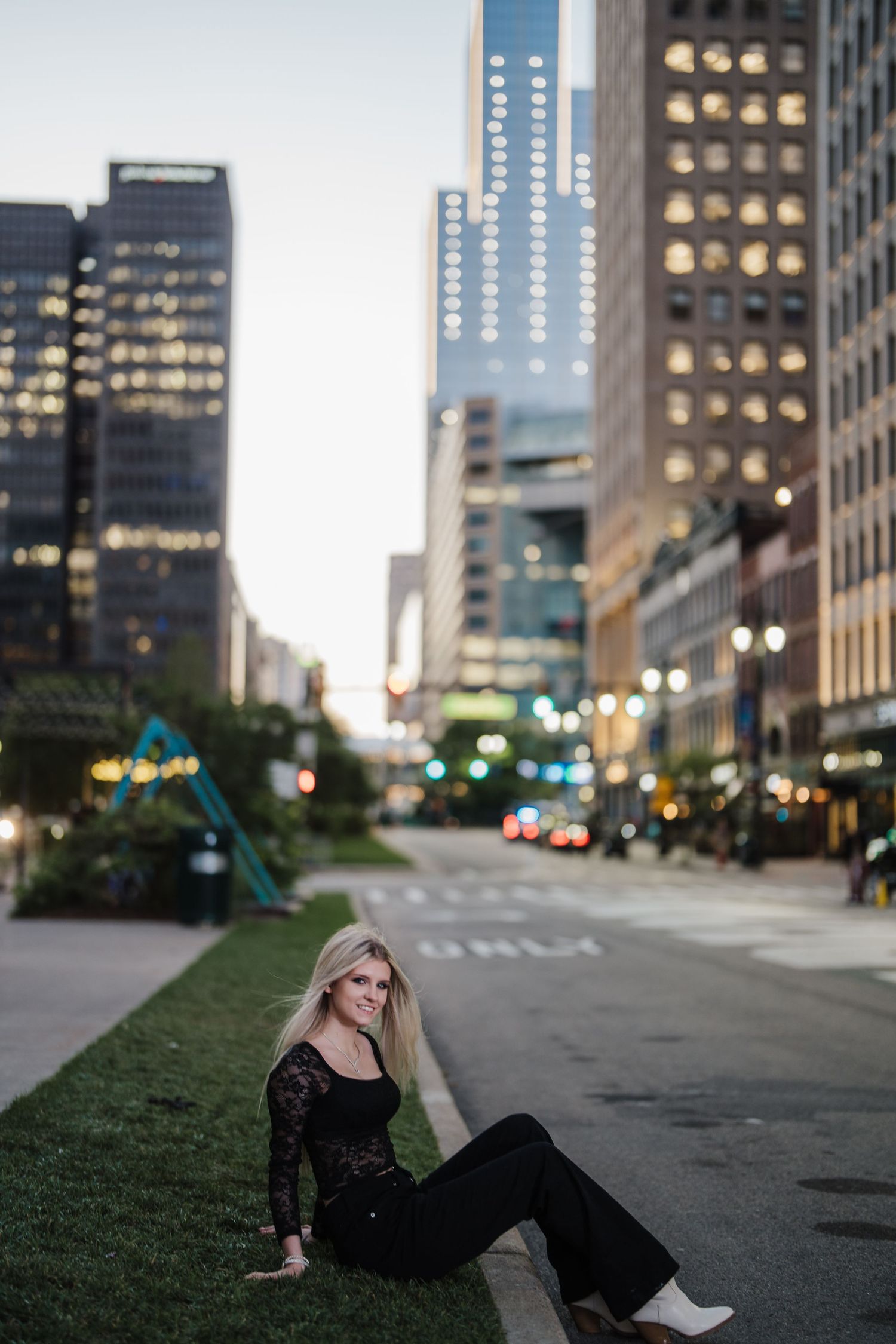 A series of five urban street photos showing a person in a black dress posing against city buildings at dusk.