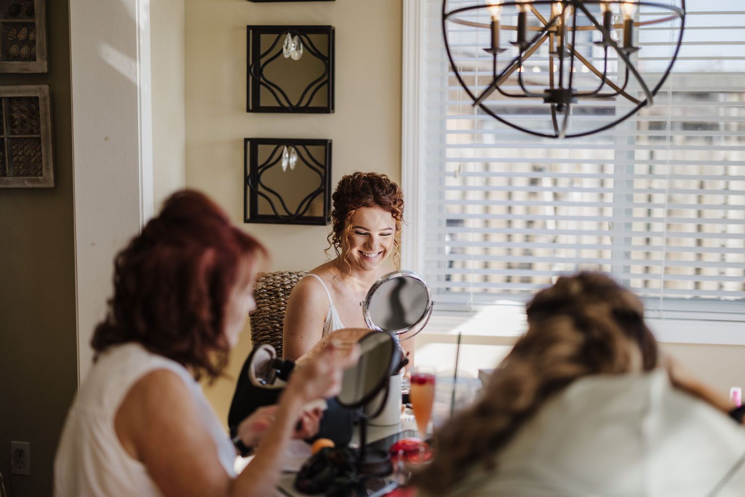 Wedding preparations scene with people getting ready in a bright room with modern decor.