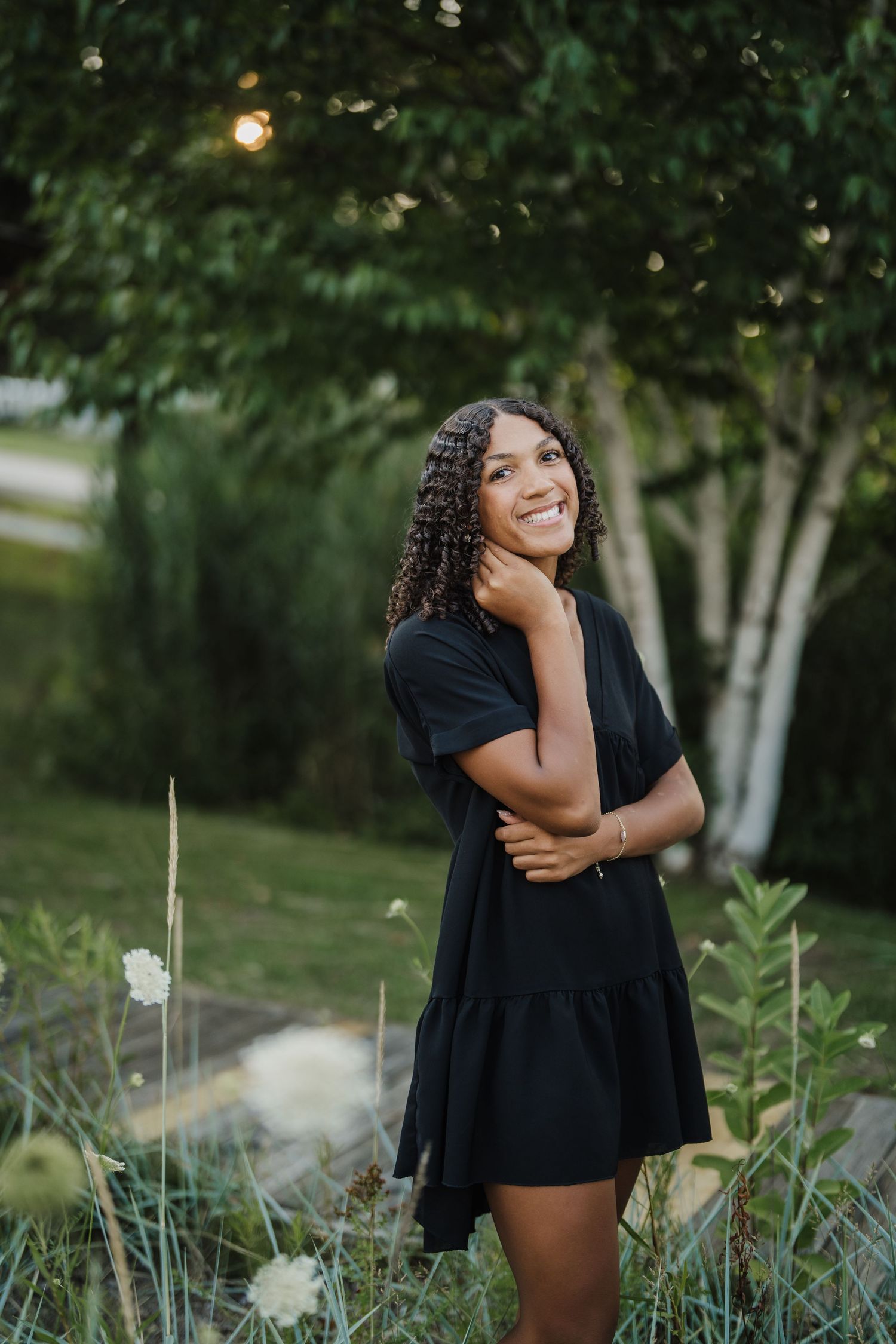 Natural outdoor photography session among blooming flowers and trees at golden hour.