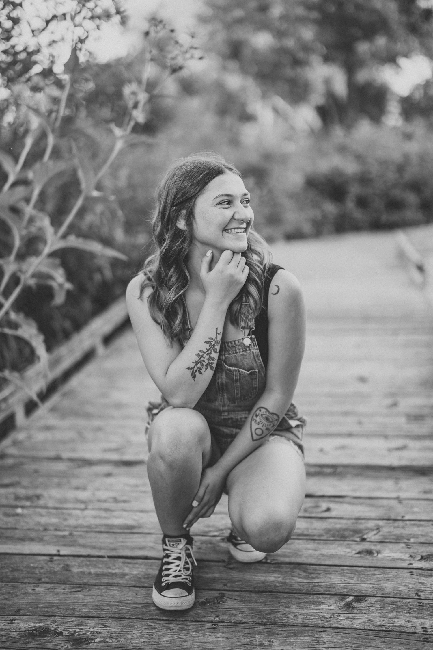 Black and white candid moments captured on a rustic wooden boardwalk.