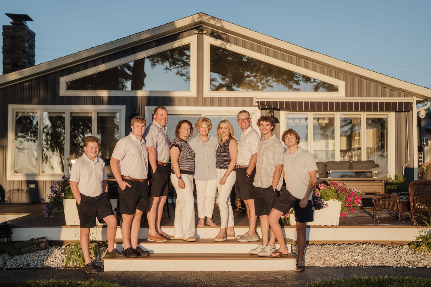 Panoramic wedding party group photos taken at sunset outside a rustic venue.
