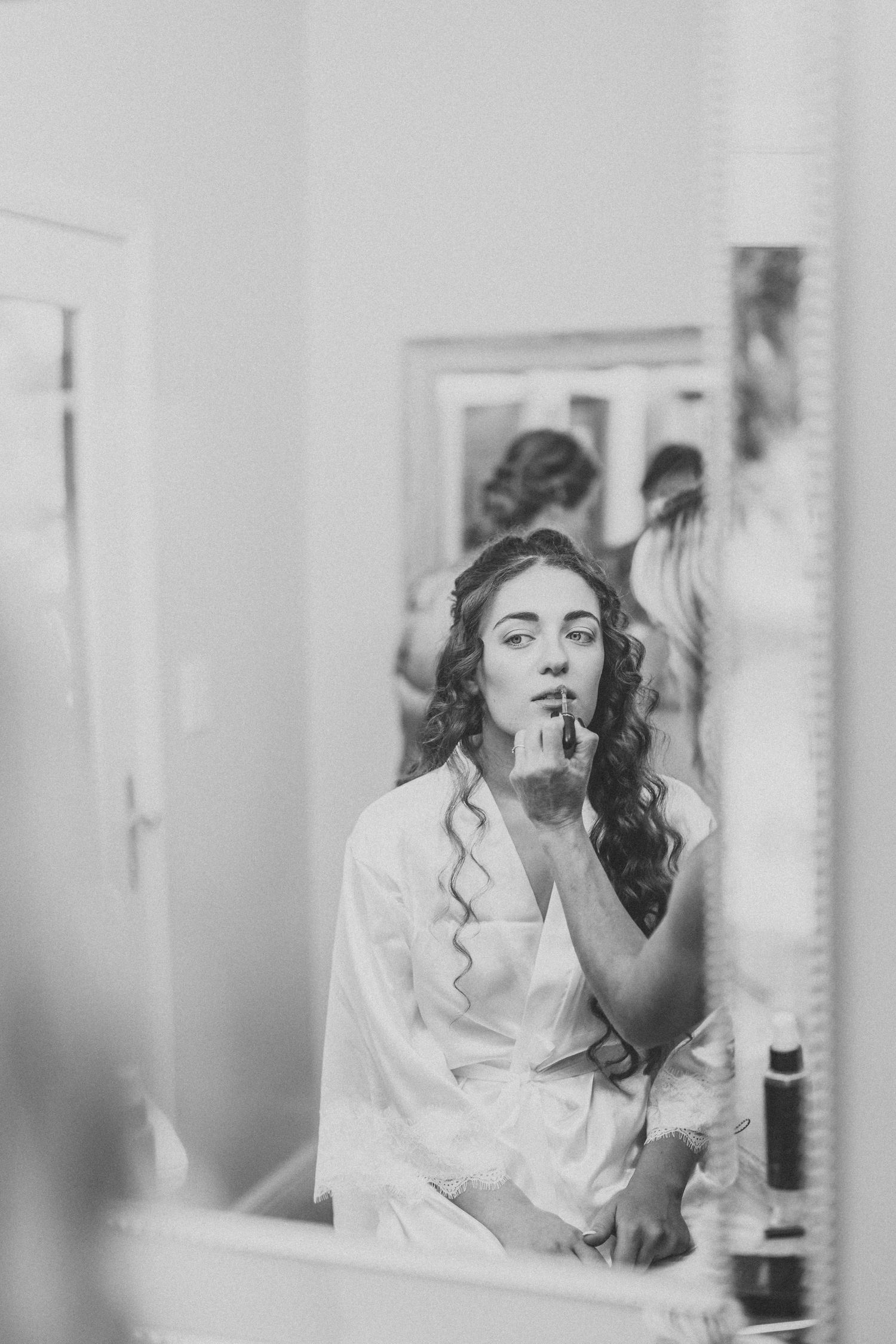 A black and white photo captures getting ready moments before a wedding ceremony.
