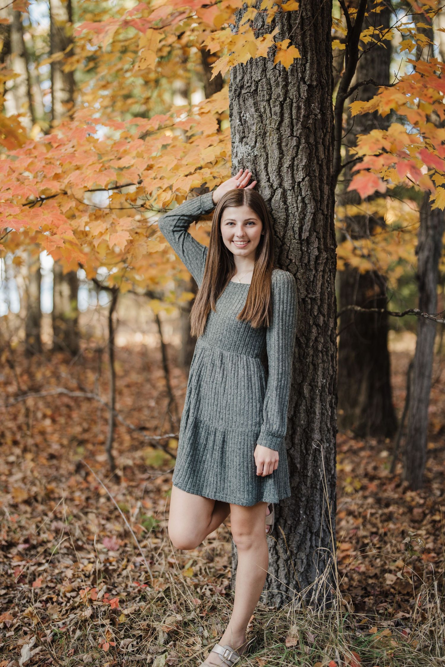 A sequence of autumn portraits featuring someone in a knit dress posing against trees with orange leaves.