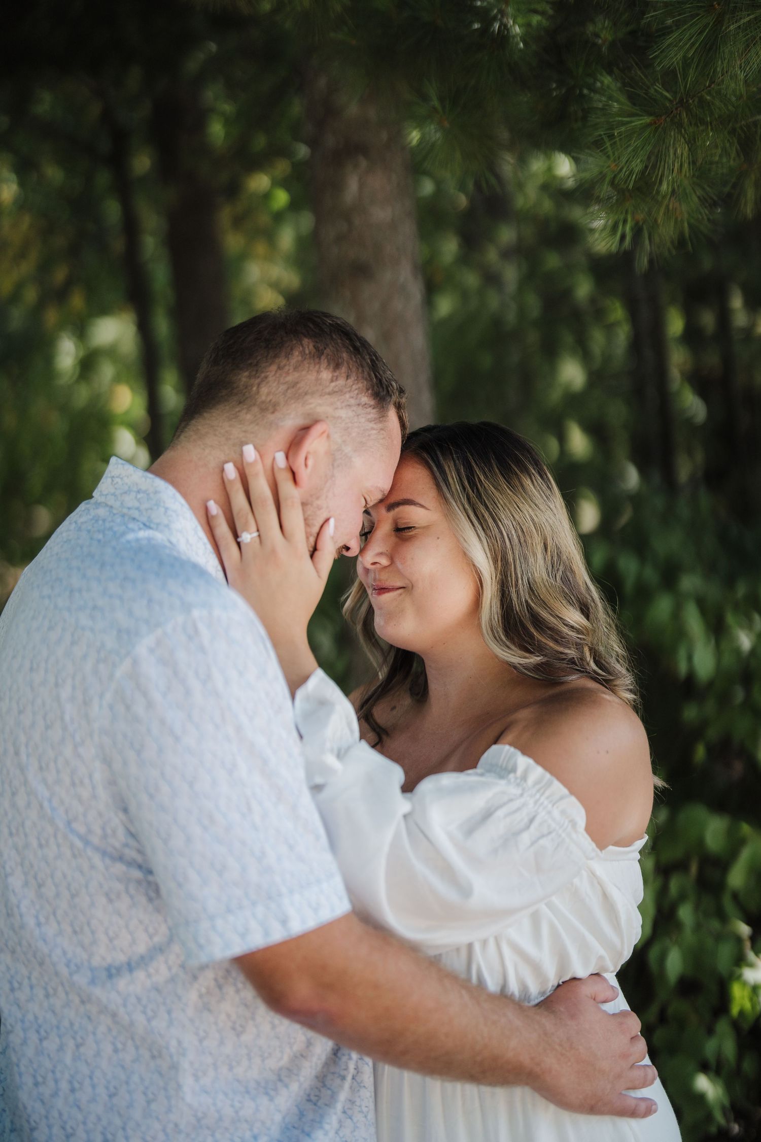 A romantic couple shares intimate moments in a series of tender embraces against a lush green outdoor backdrop.