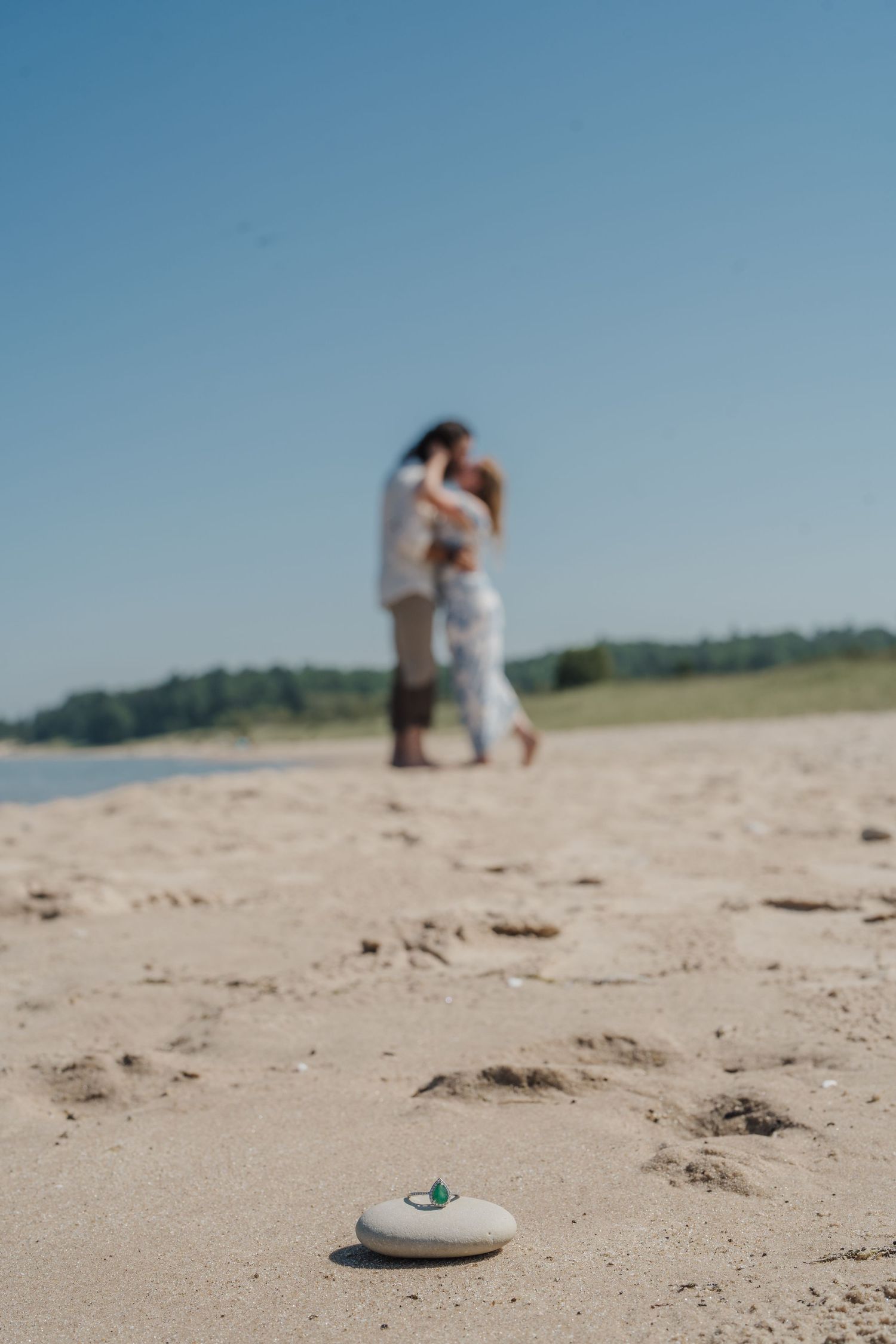 Three progressive beach photos show figures in the distance with a small object in focus on the sandy foreground.