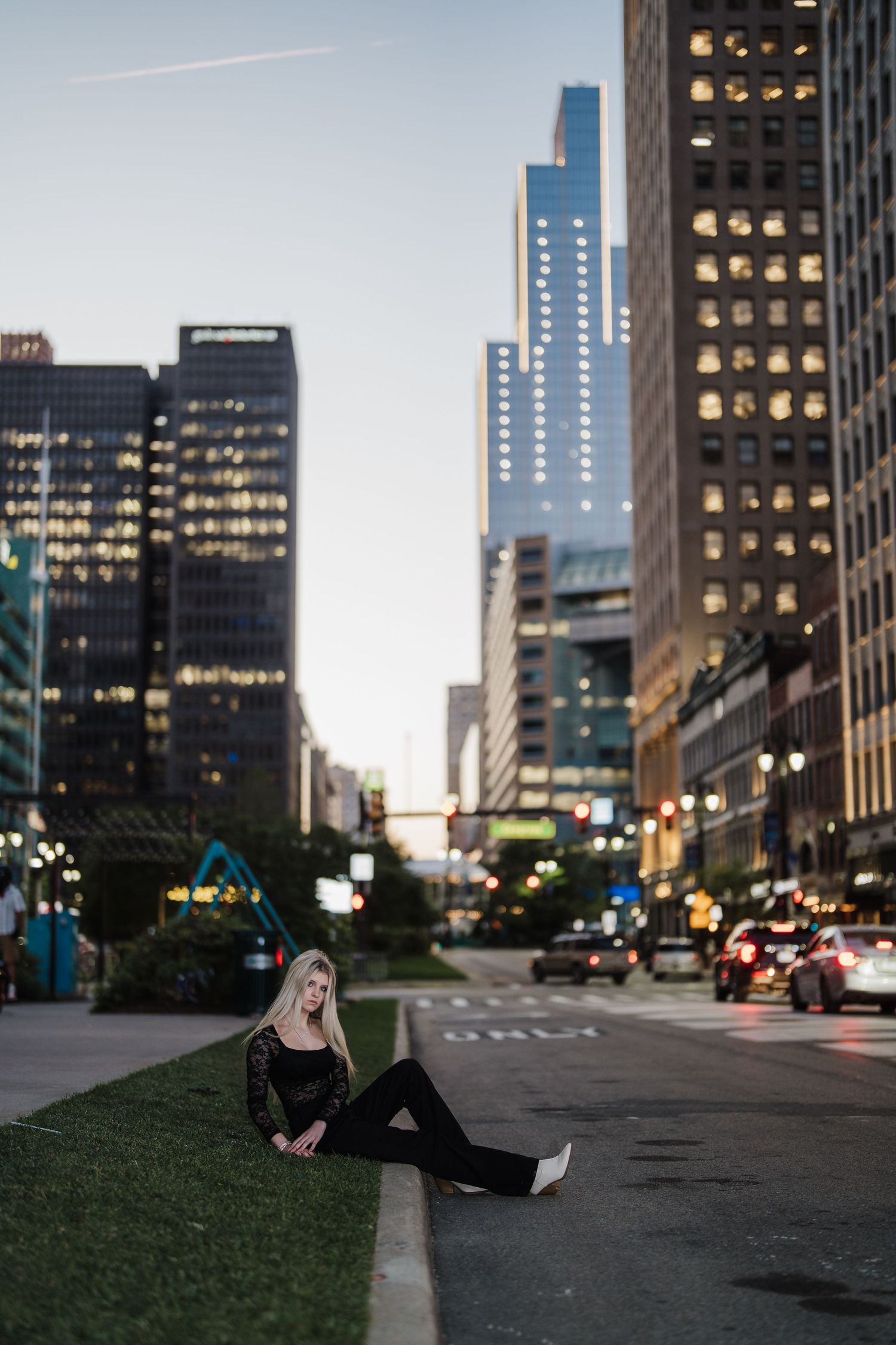 Artistic street photography at dusk showcasing illuminated office buildings and city streets.