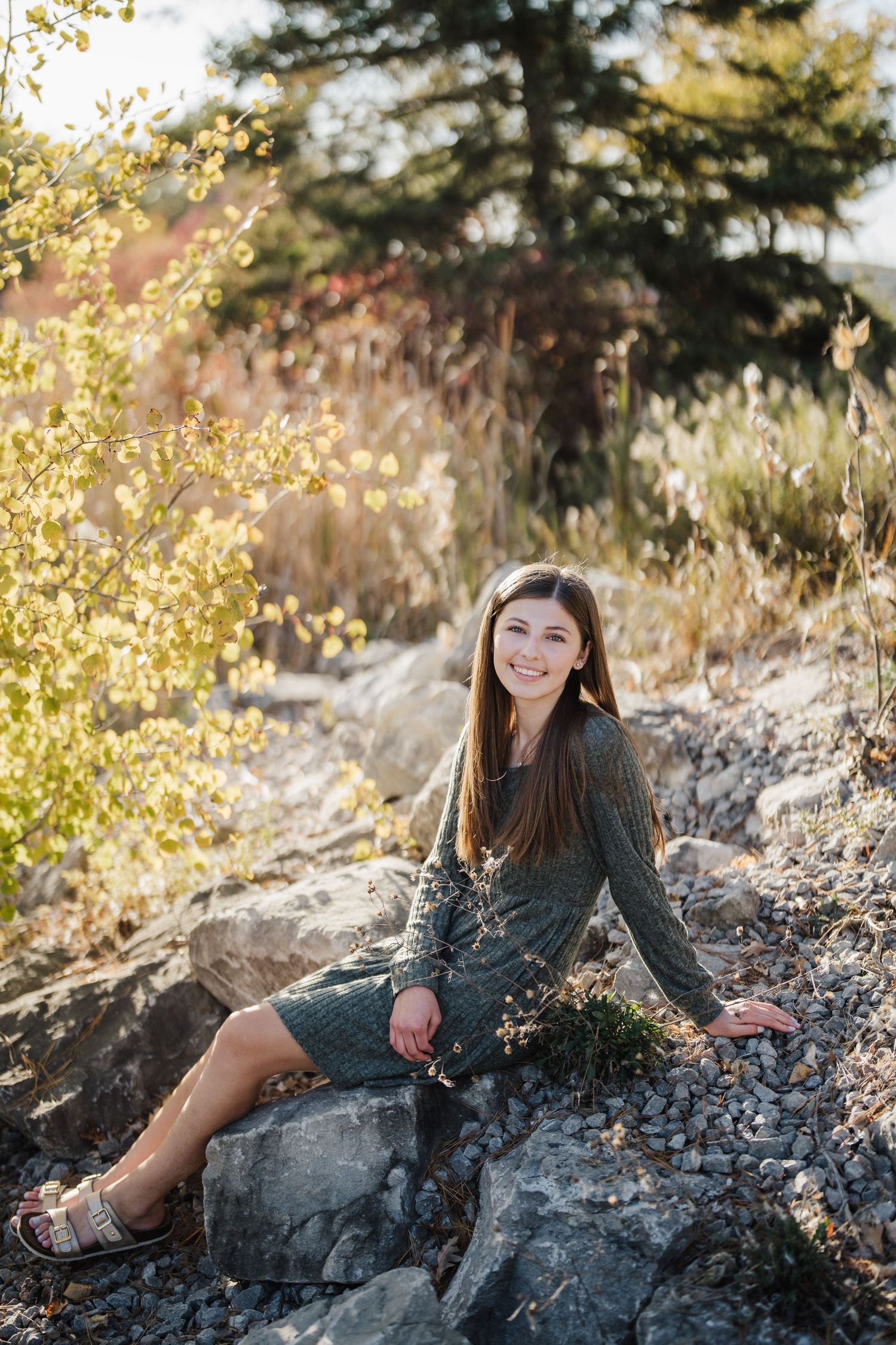 A sequence of portraits captured on rocky terrain with autumn foliage in the background.