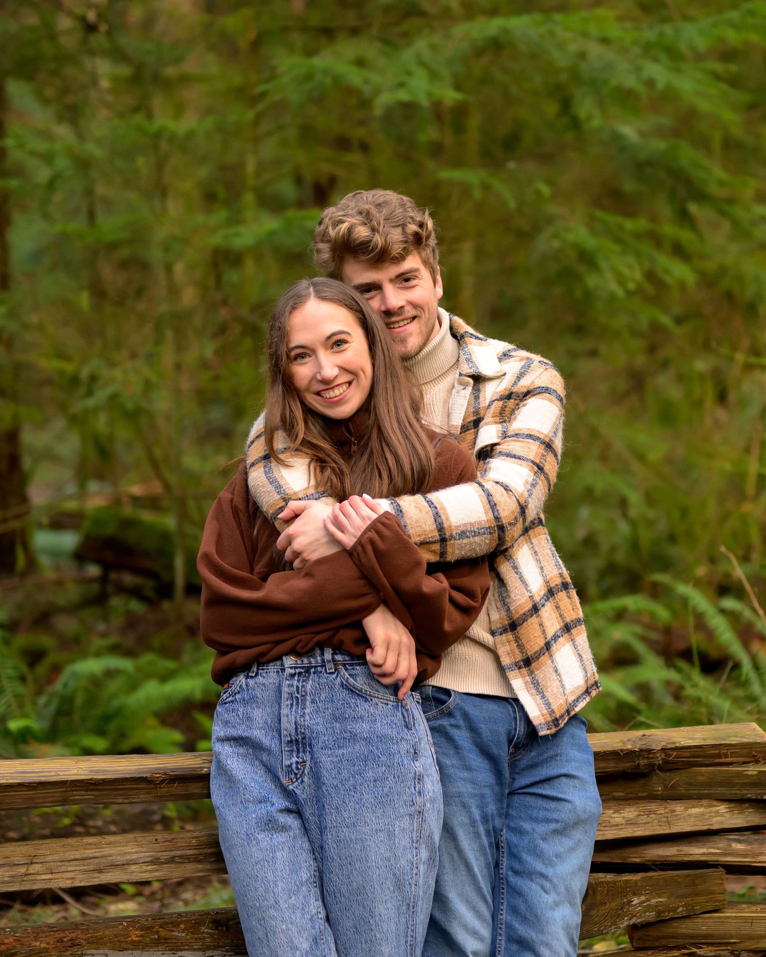 Sweet moment shared on a rustic wooden fence in a peaceful forest setting.