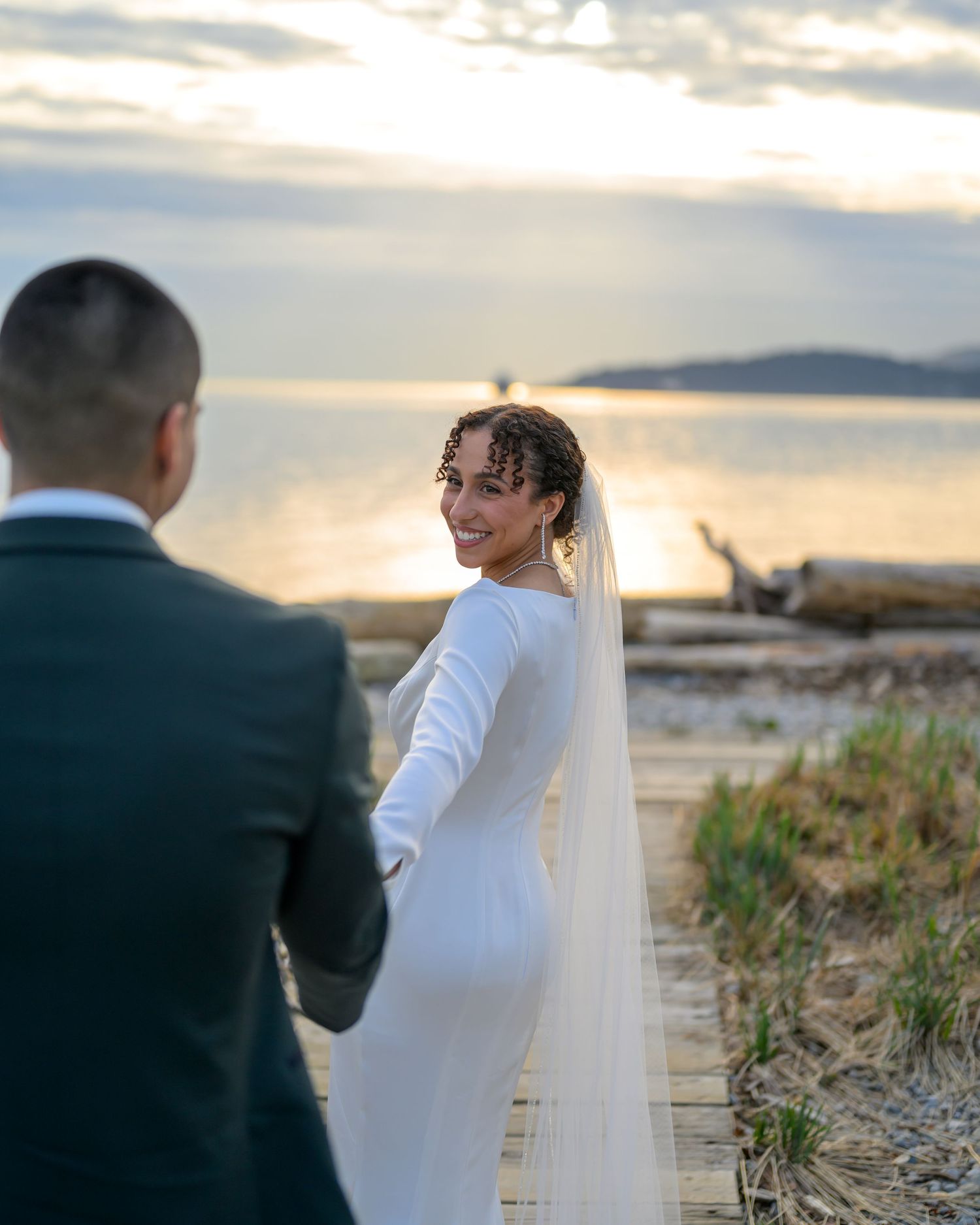 Couple shares an intimate moment during sunset beach wedding photoshoot.