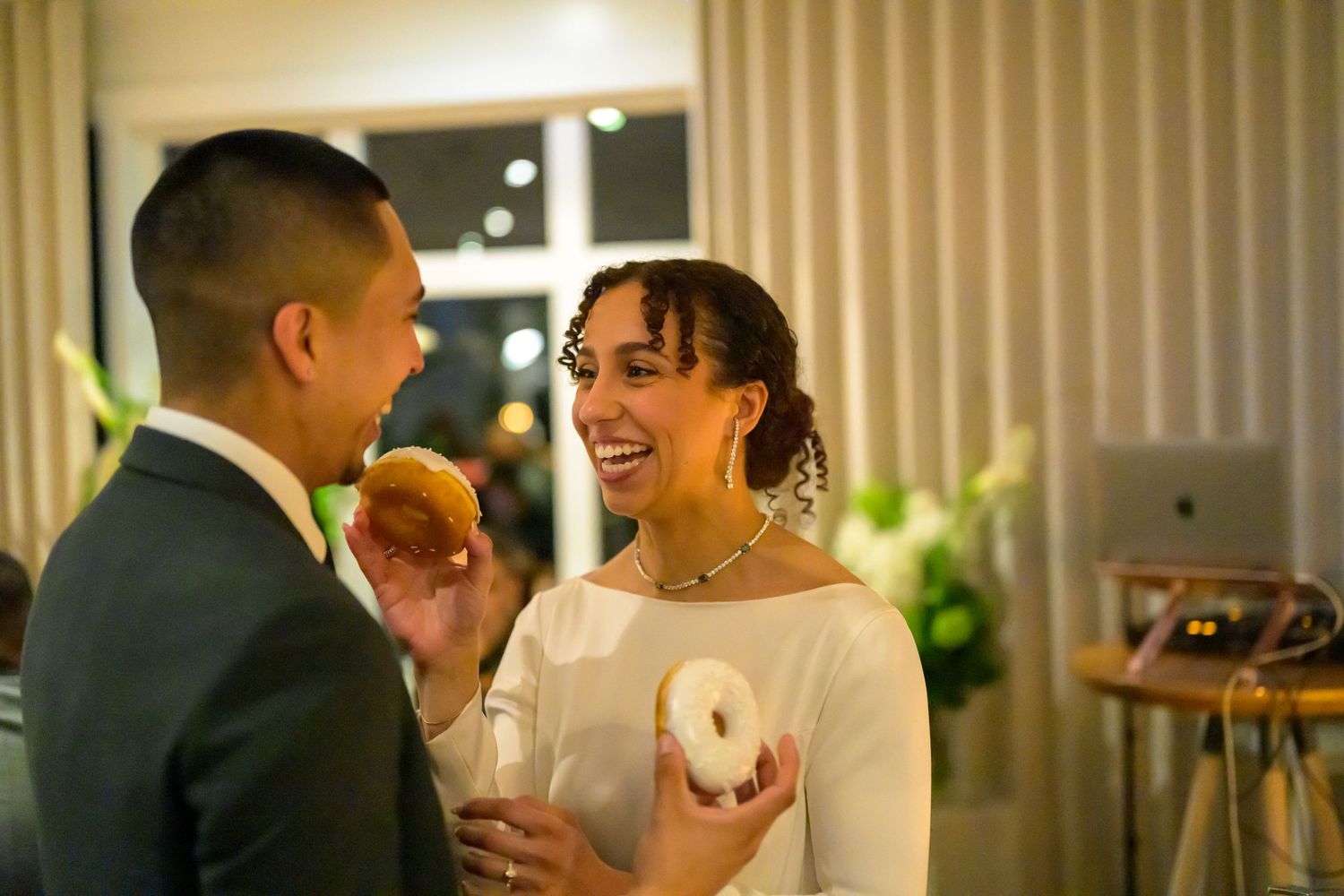 Wedding reception celebration with string lights in an elegant indoor venue.