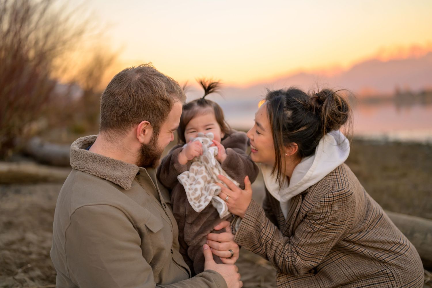 Family with young child on a beach in Port Coquitlam during sunset