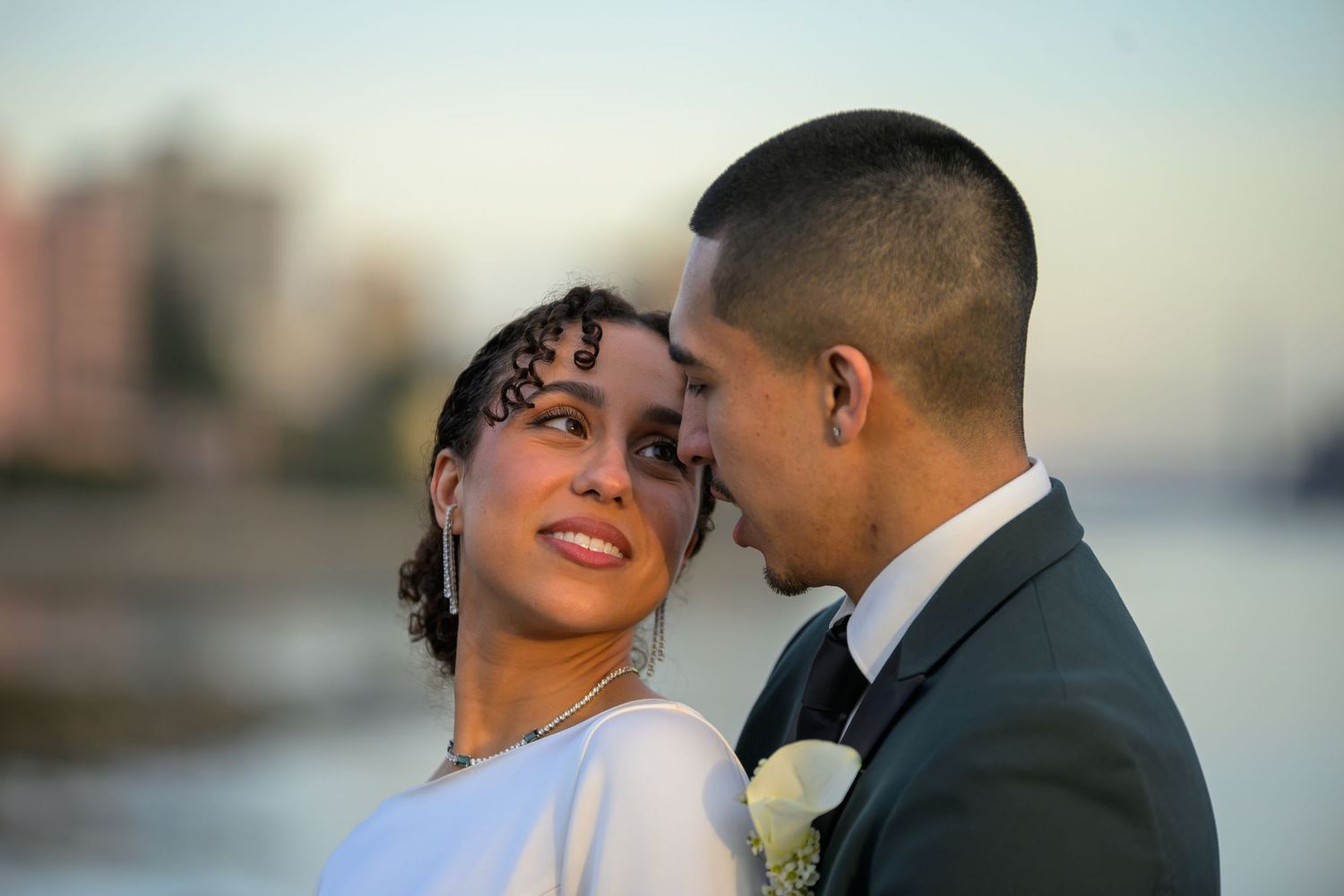 Romantic sunset portraits of newlyweds by the ocean.