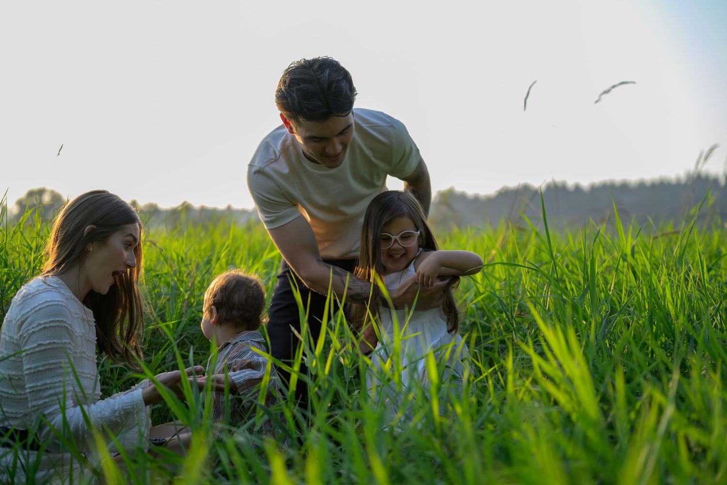 Group relaxing together in tall grass during a summer day.