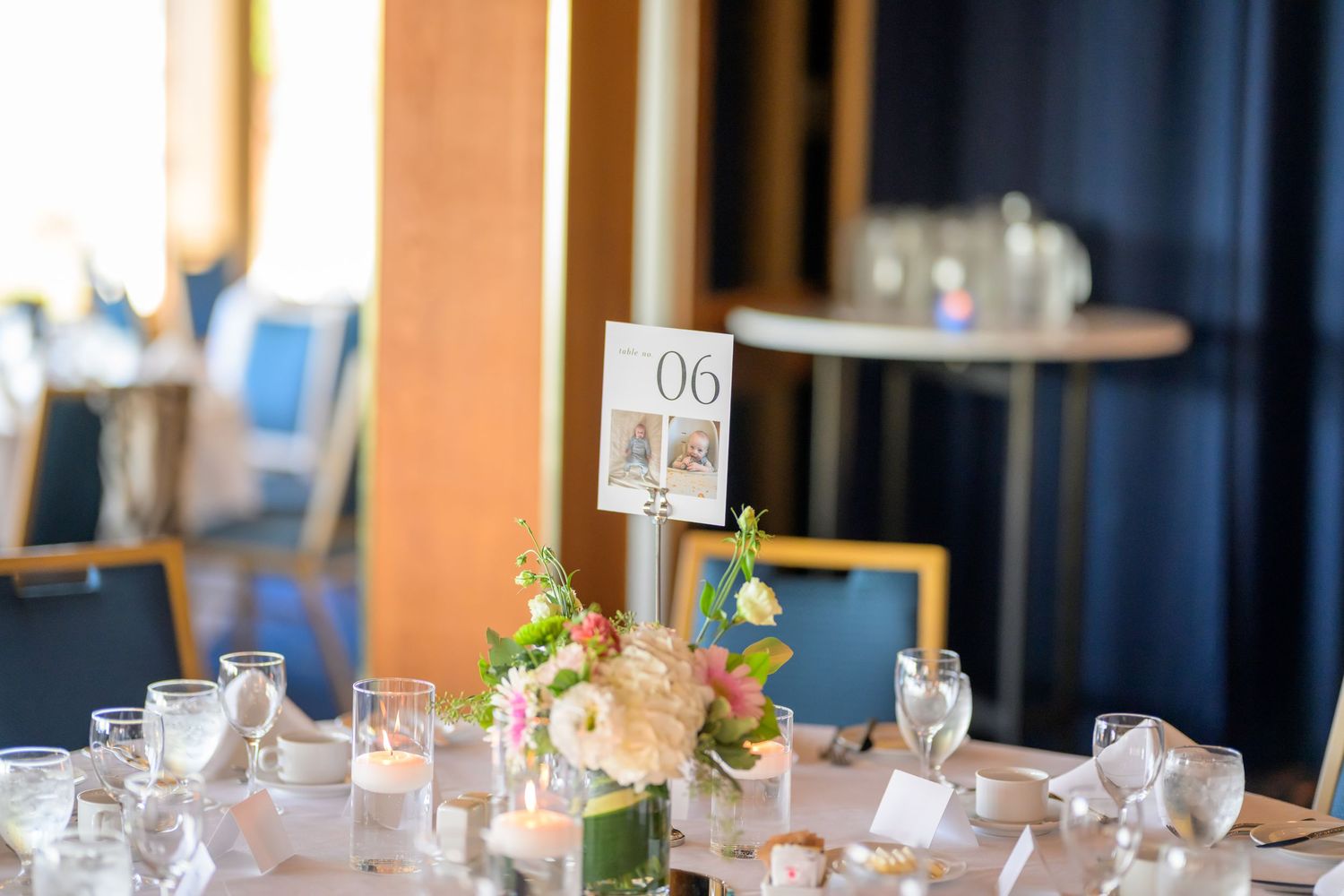 Elegant wedding reception tables decorated with floral arrangements and place settings.