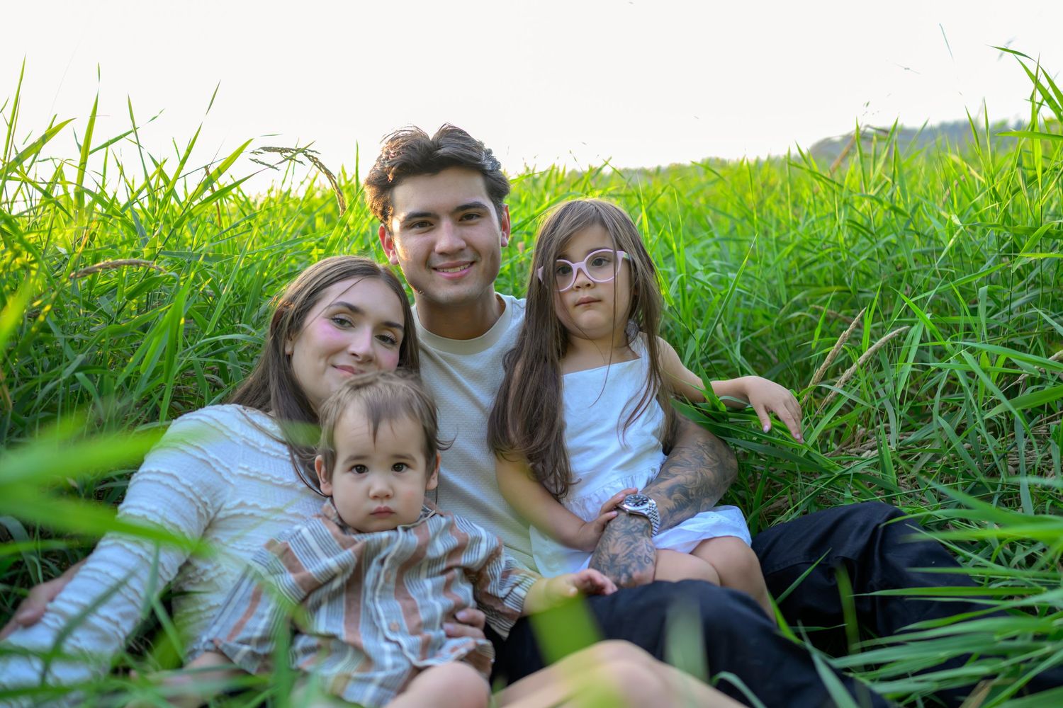 People relaxing together in a lush green meadow on a sunny afternoon.