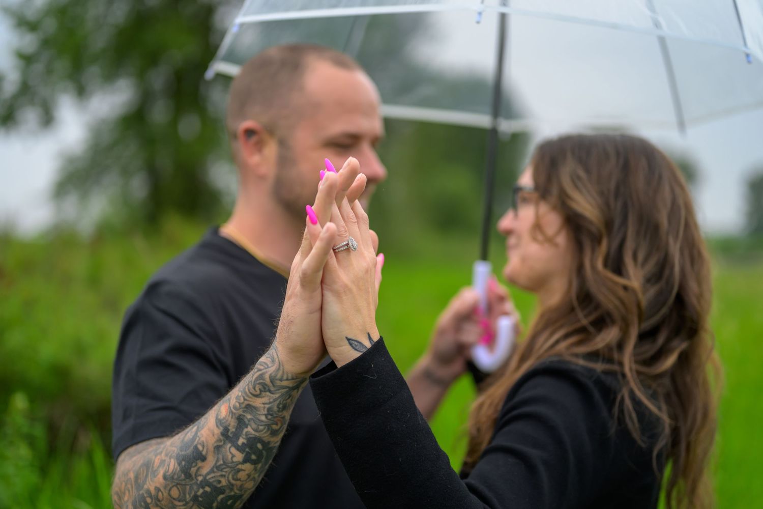 Intimate couple portraits captured in a meadow during overcast weather.