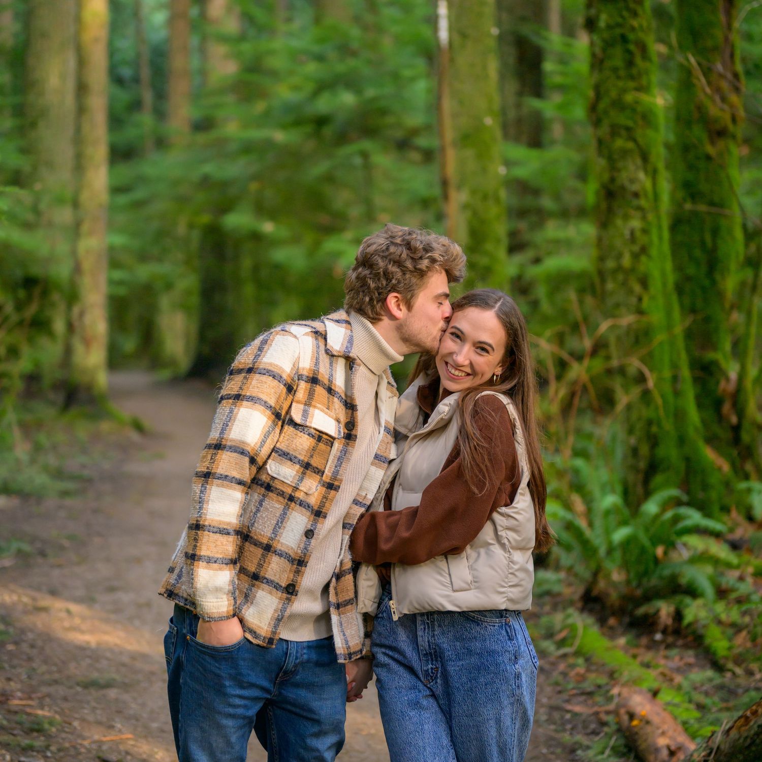 Cozy autumn scene on a forest trail with evergreen trees in the background.