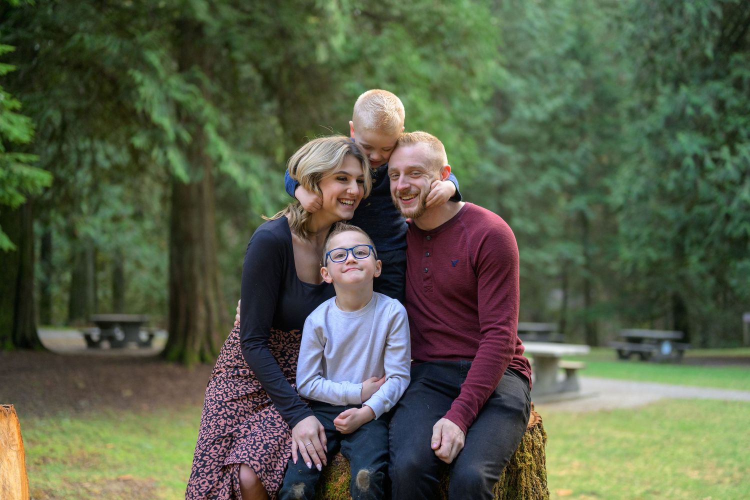 Family portraits in Maple Ridge Park. Lush green forest in background