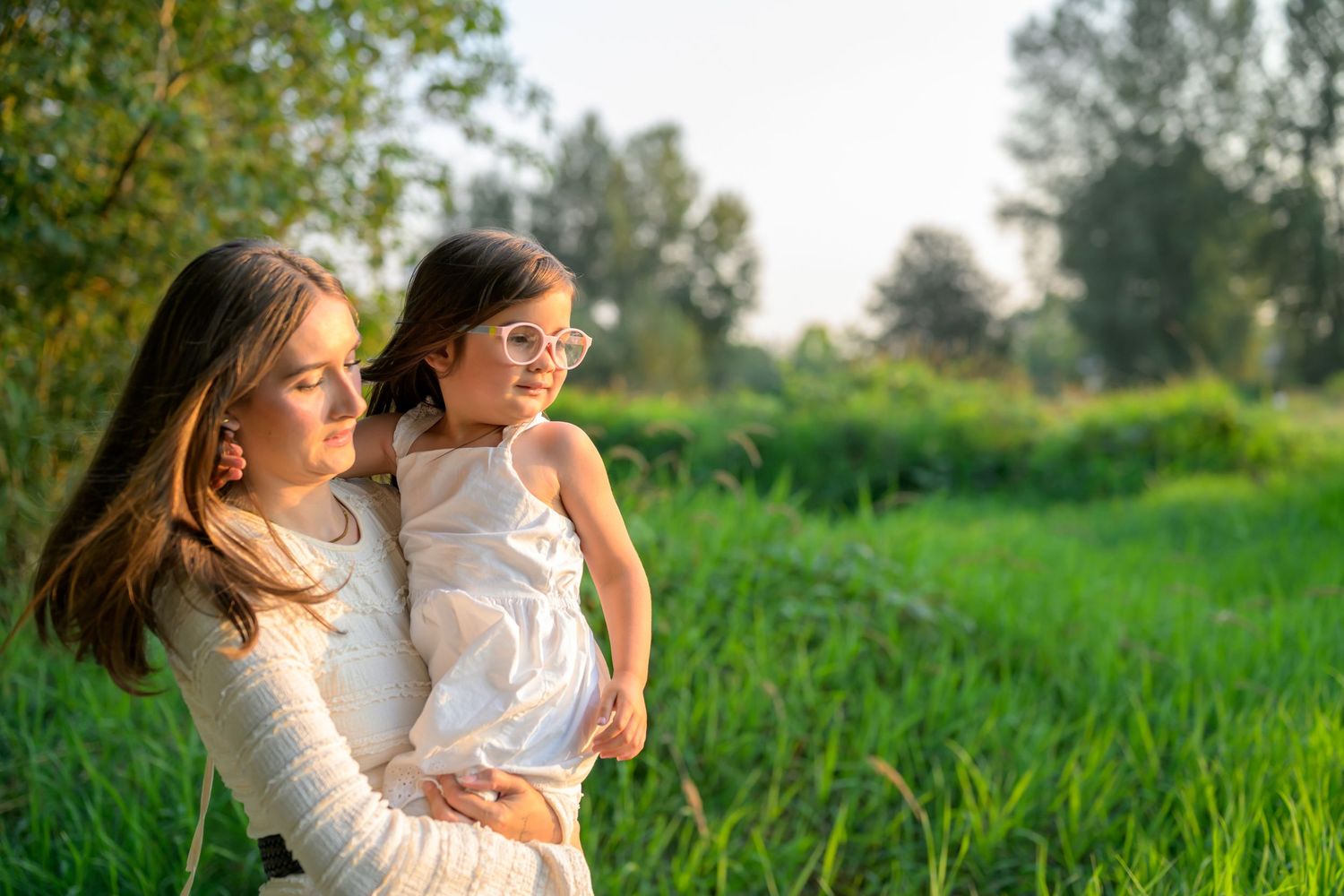 People enjoying a sunny day in a vibrant green field.