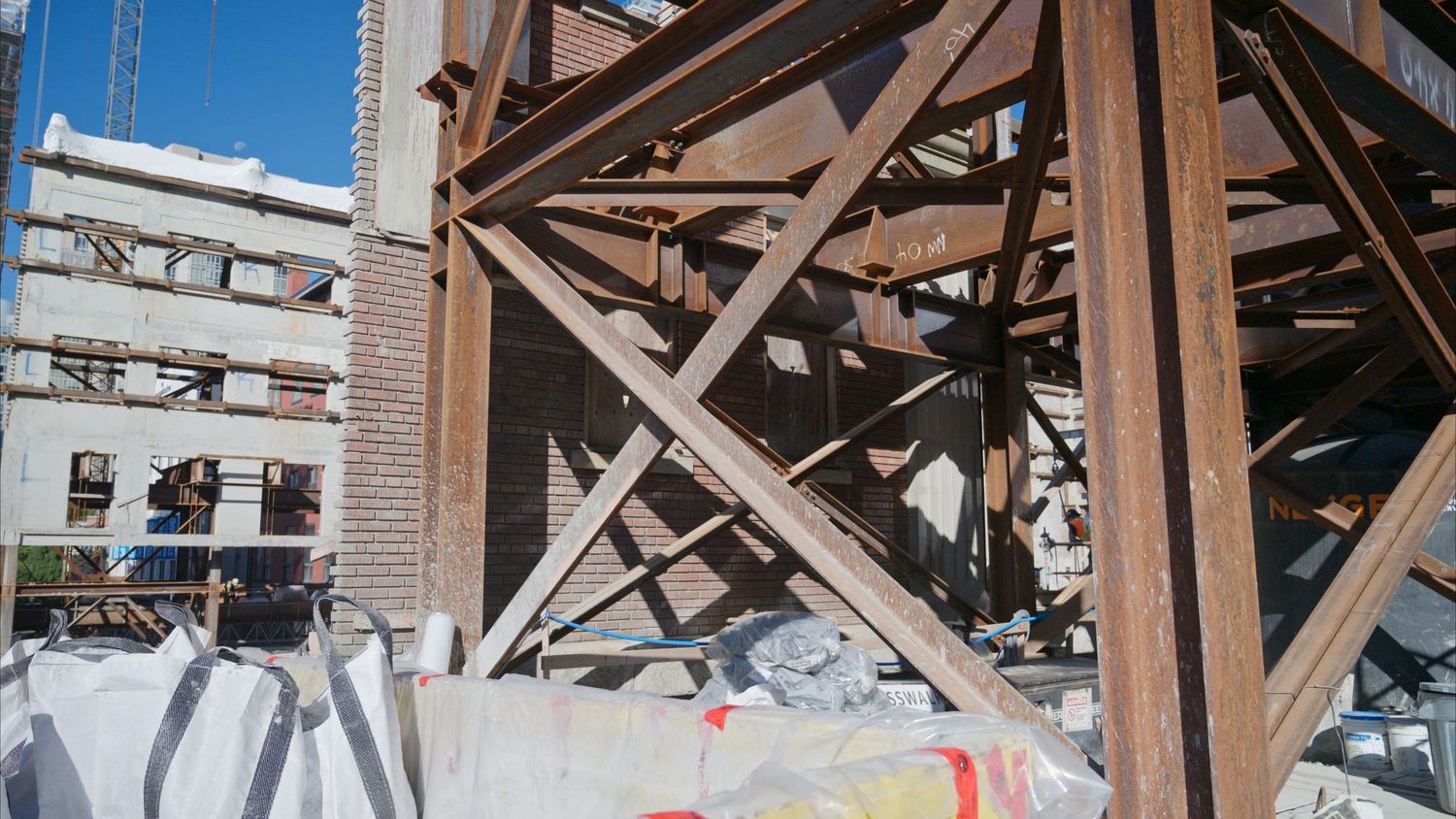 Wide angle view of steel beam construction framework against clear sky.