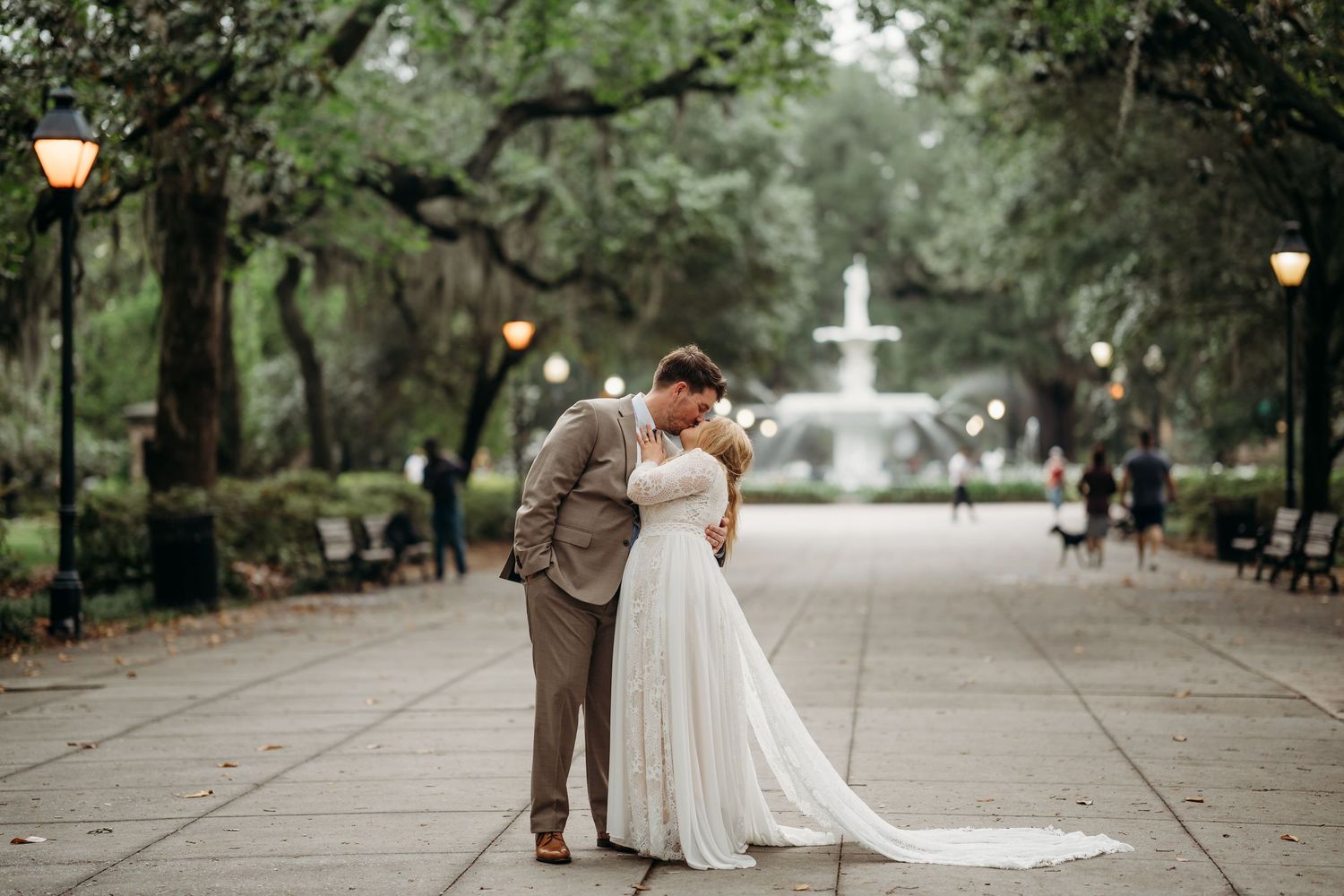Bride and groom share romantic forehead touch near Forsyth Park fountain in Savannah, Georgia.
