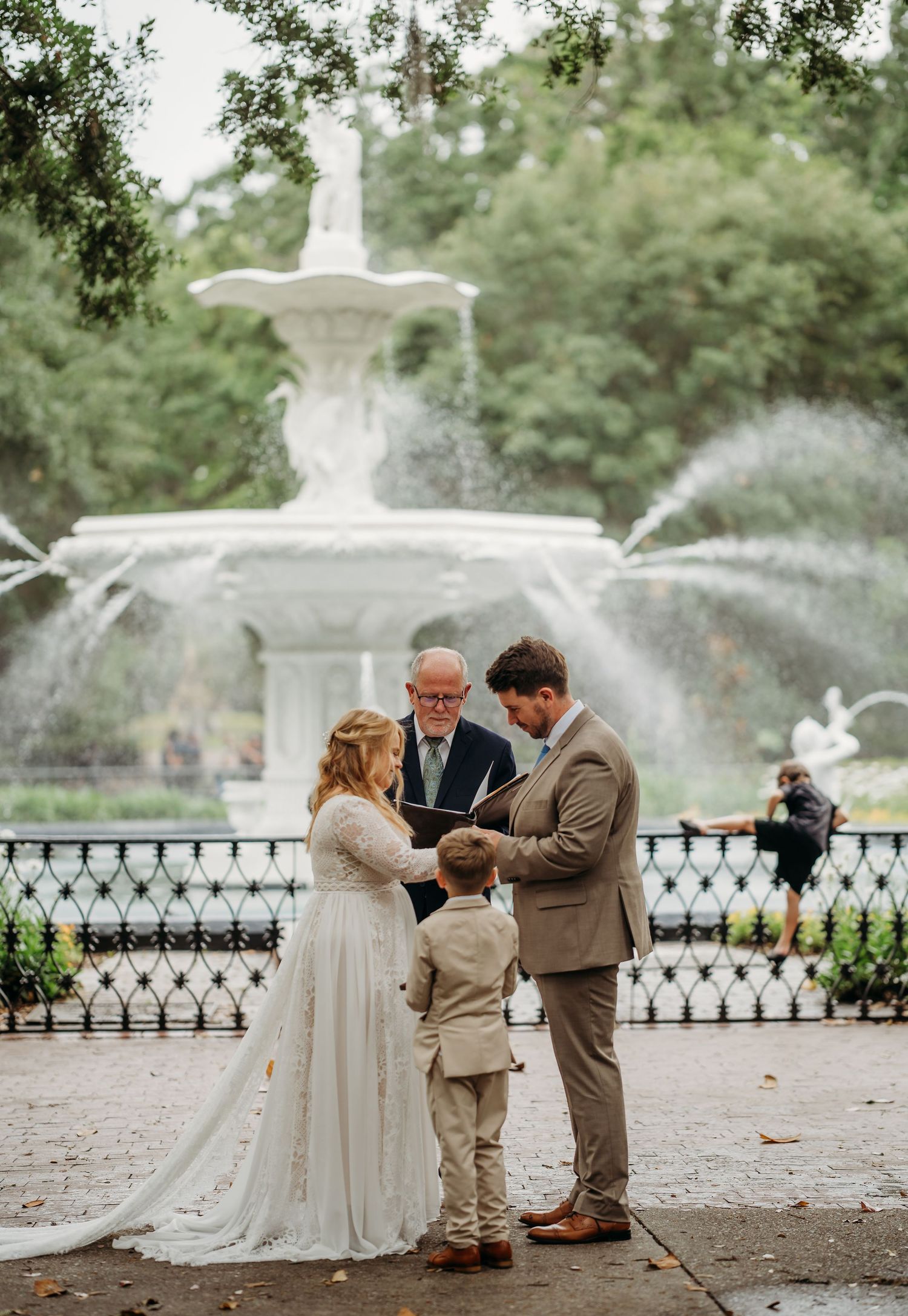 Bride and groom exchanging vows at Forsyth Park fountain wedding ceremony in Savannah.