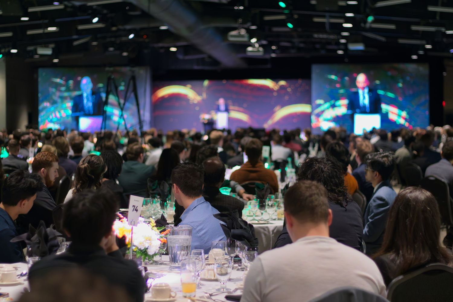 Photo of people and speakers in a gala