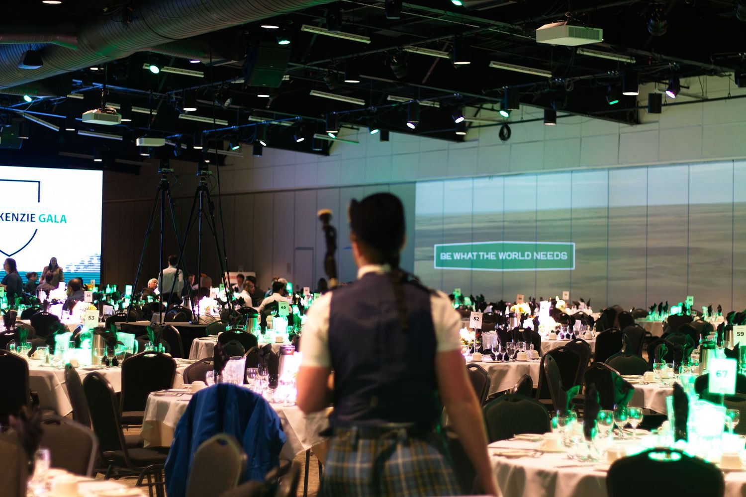 Man with bagpipes at a gala with set tables