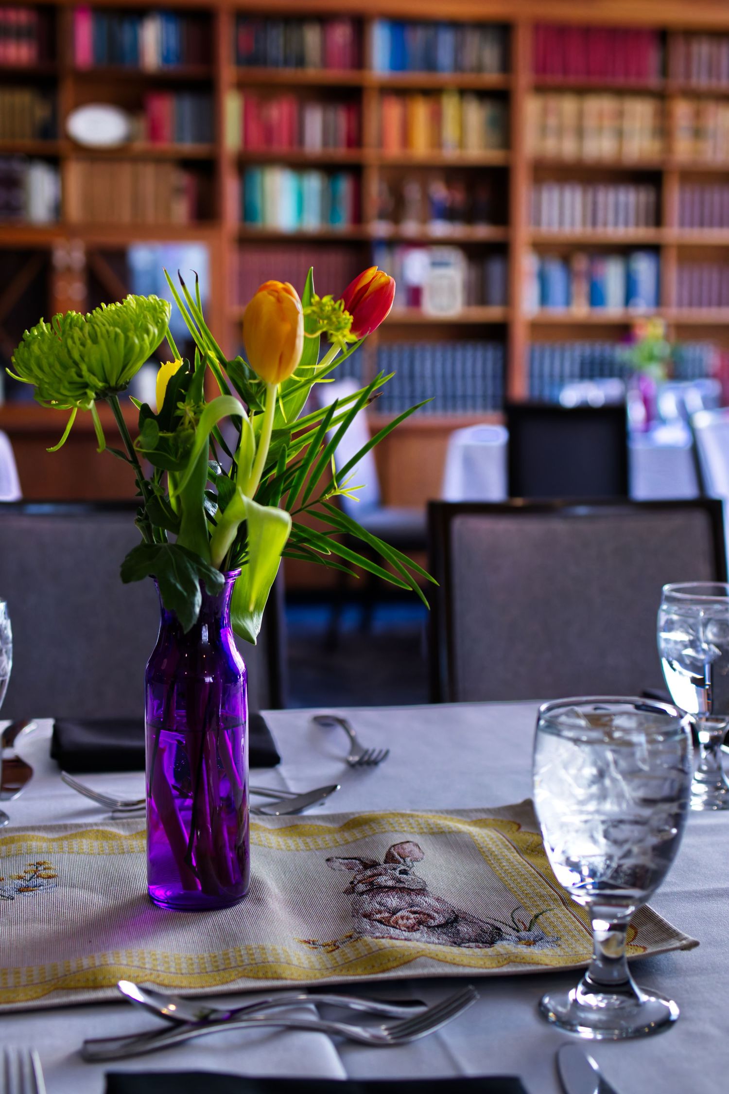 A library picture of Easter decorations and water glasses on a dining table