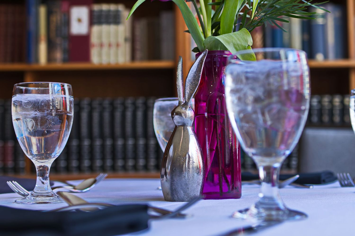 A library picture of Easter decorations and water glasses on a dining table
