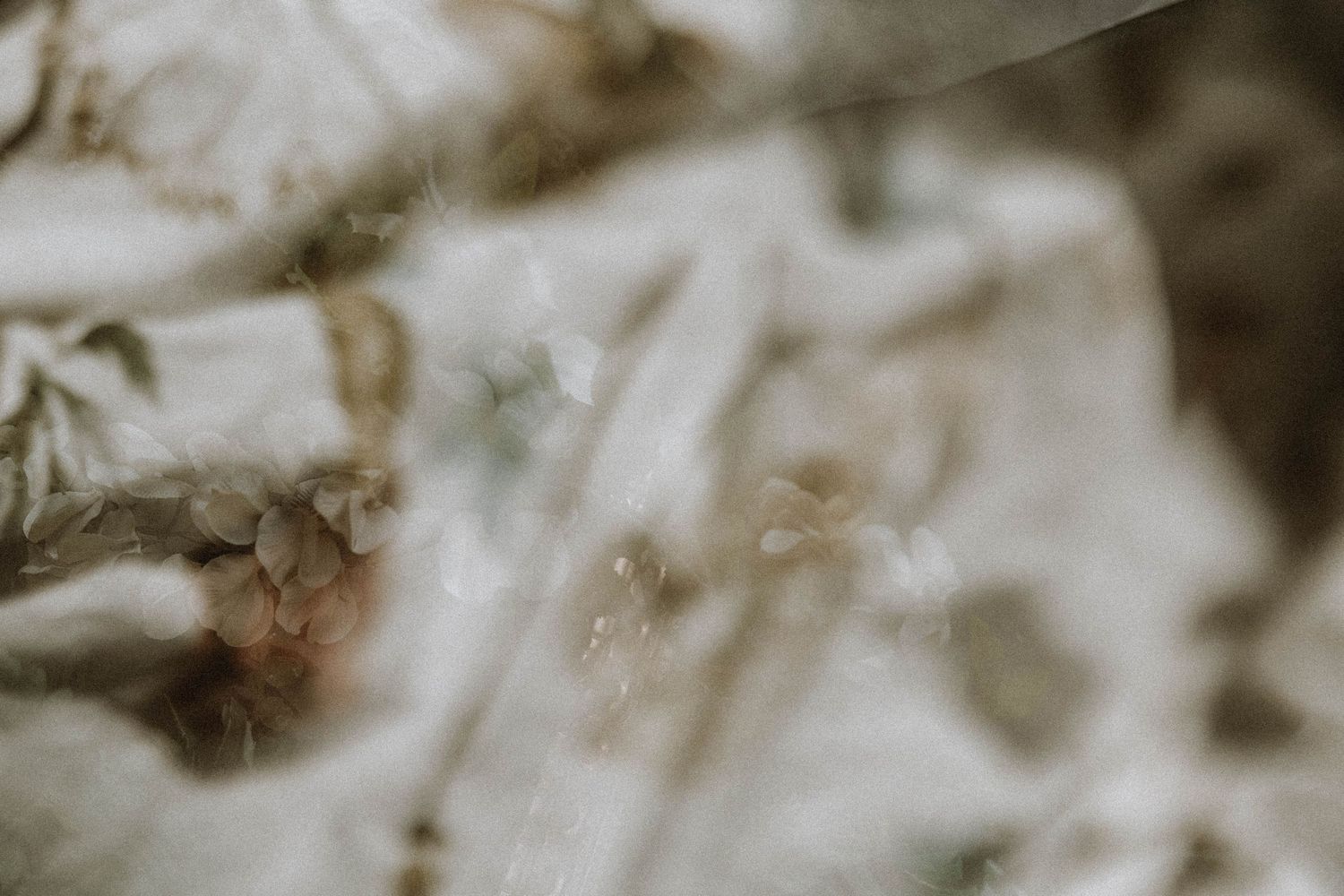 Soft blurred botanical print fabric with delicate floral and leaf patterns in muted earth tones.
