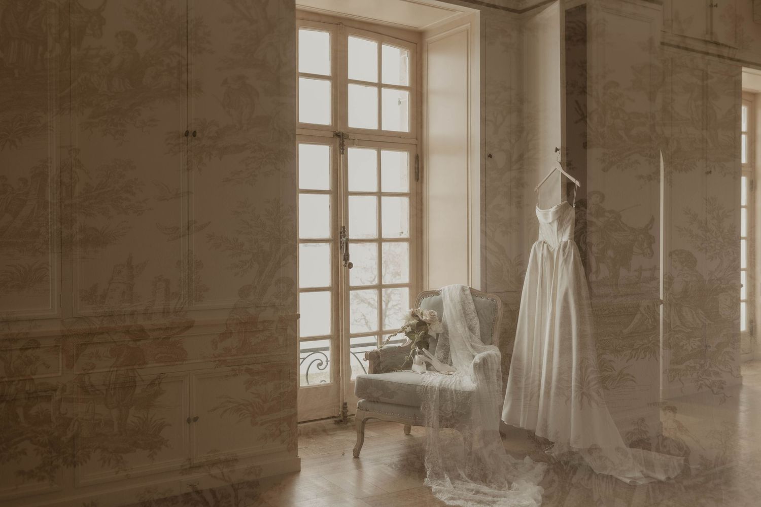 Bridal gown hanging near French windows with veil draped over vintage chair in sunlit ornate room.

top rated RI wedding photographer